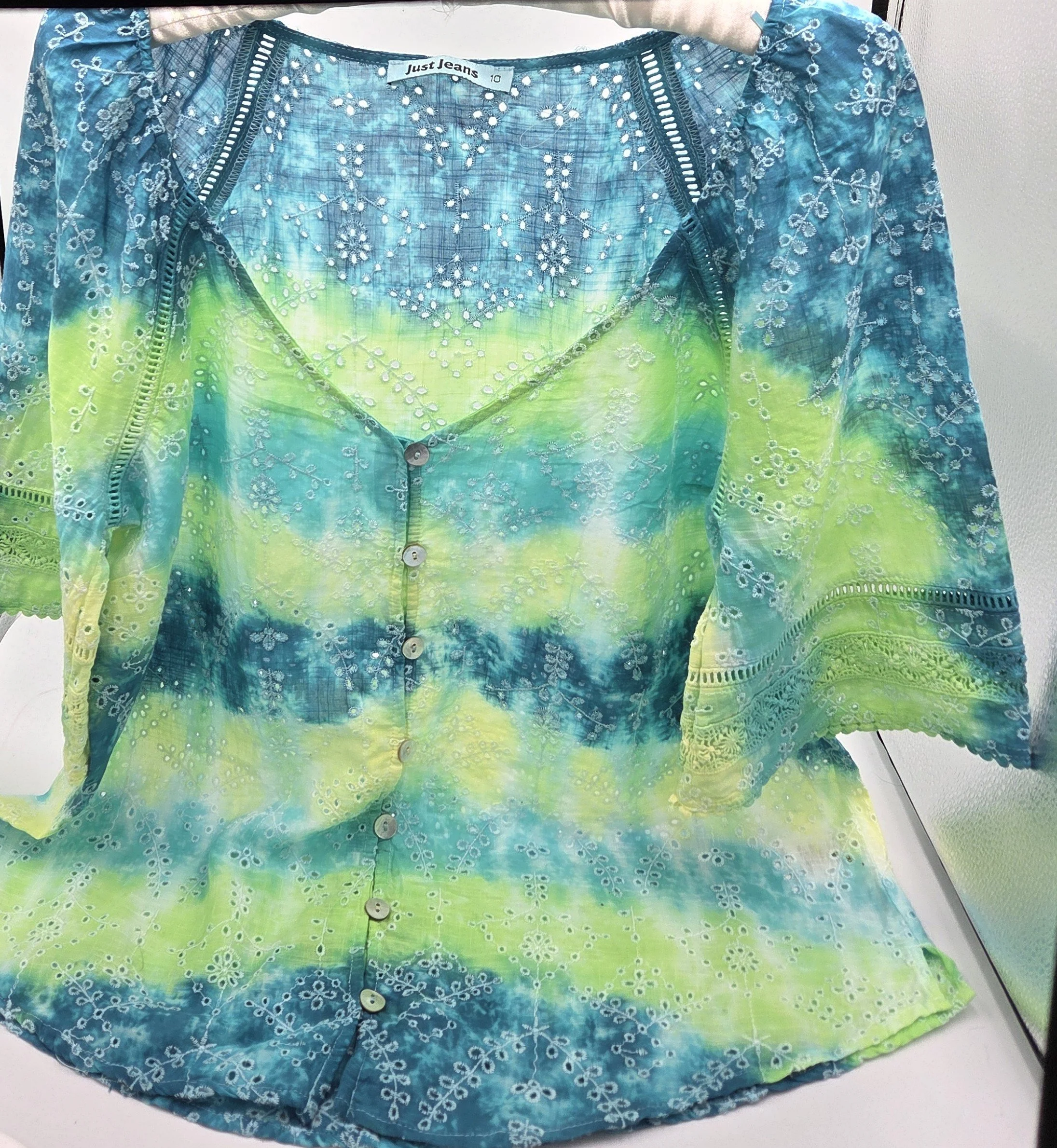 women's size 10 V-neck top with overlocked fern eyelets and horizontal tie-dye bands in green, lime, teal, and yellow.