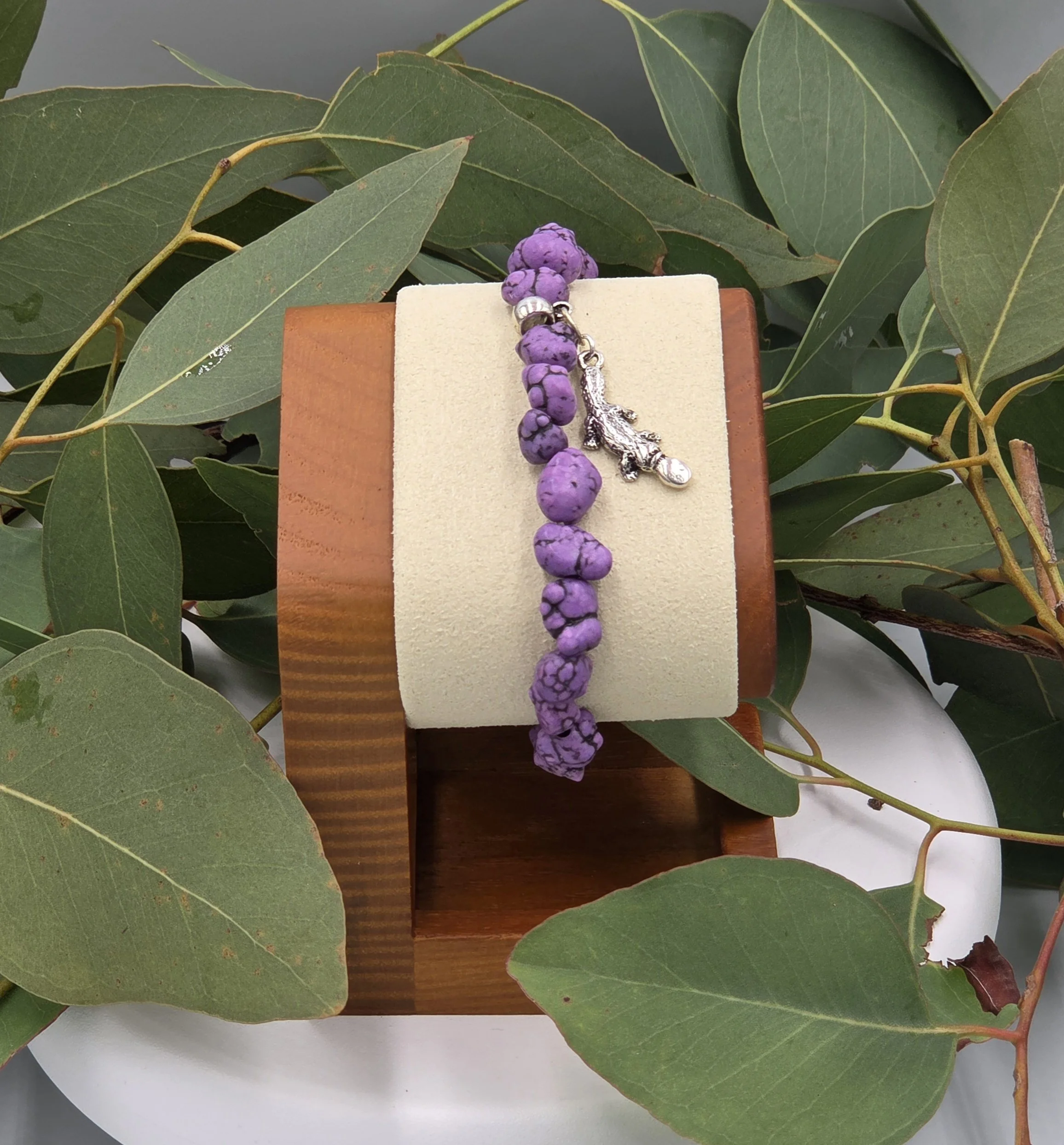 OOAK purple Howlite nugget bracelet with silver platypus charm with background of gum leaves.