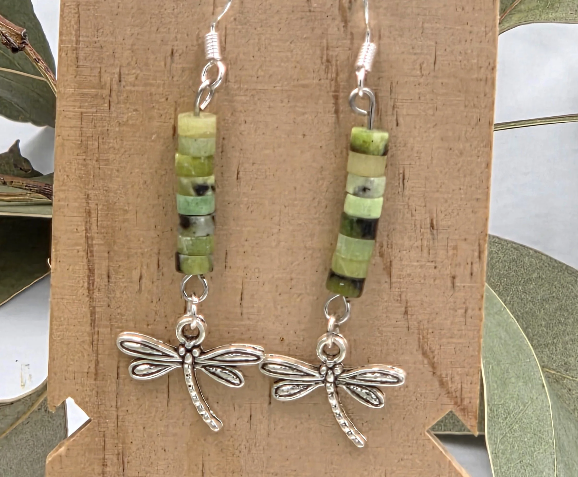 Soft green Chrysoprase beads with a delicate silver dragonfly charm on sterling silver dangle earring hooks.