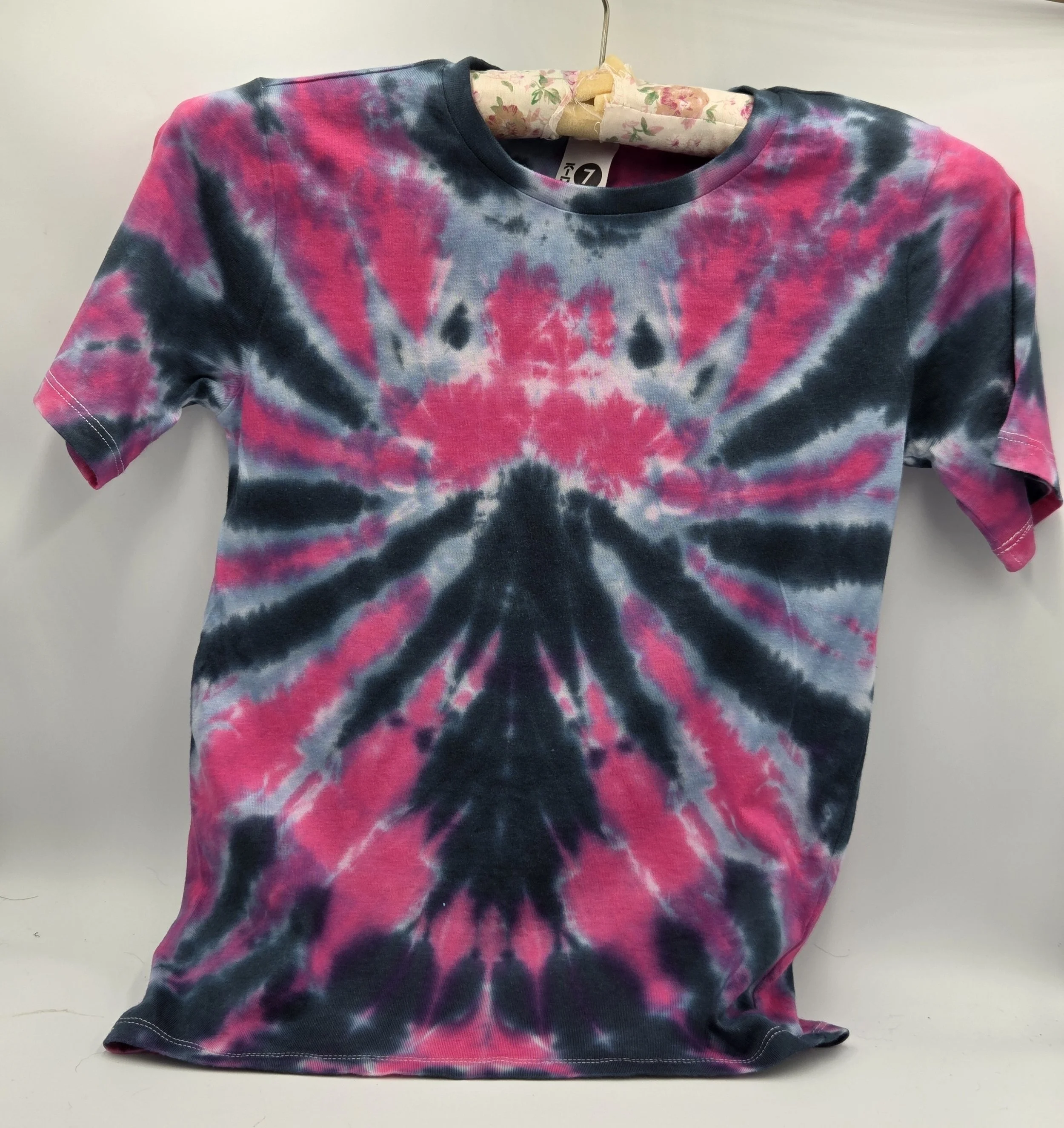 A child size 7 cotton t-shirt featuring a dramatic fuchsia and black spider tie-dye pattern with soft grey accents.