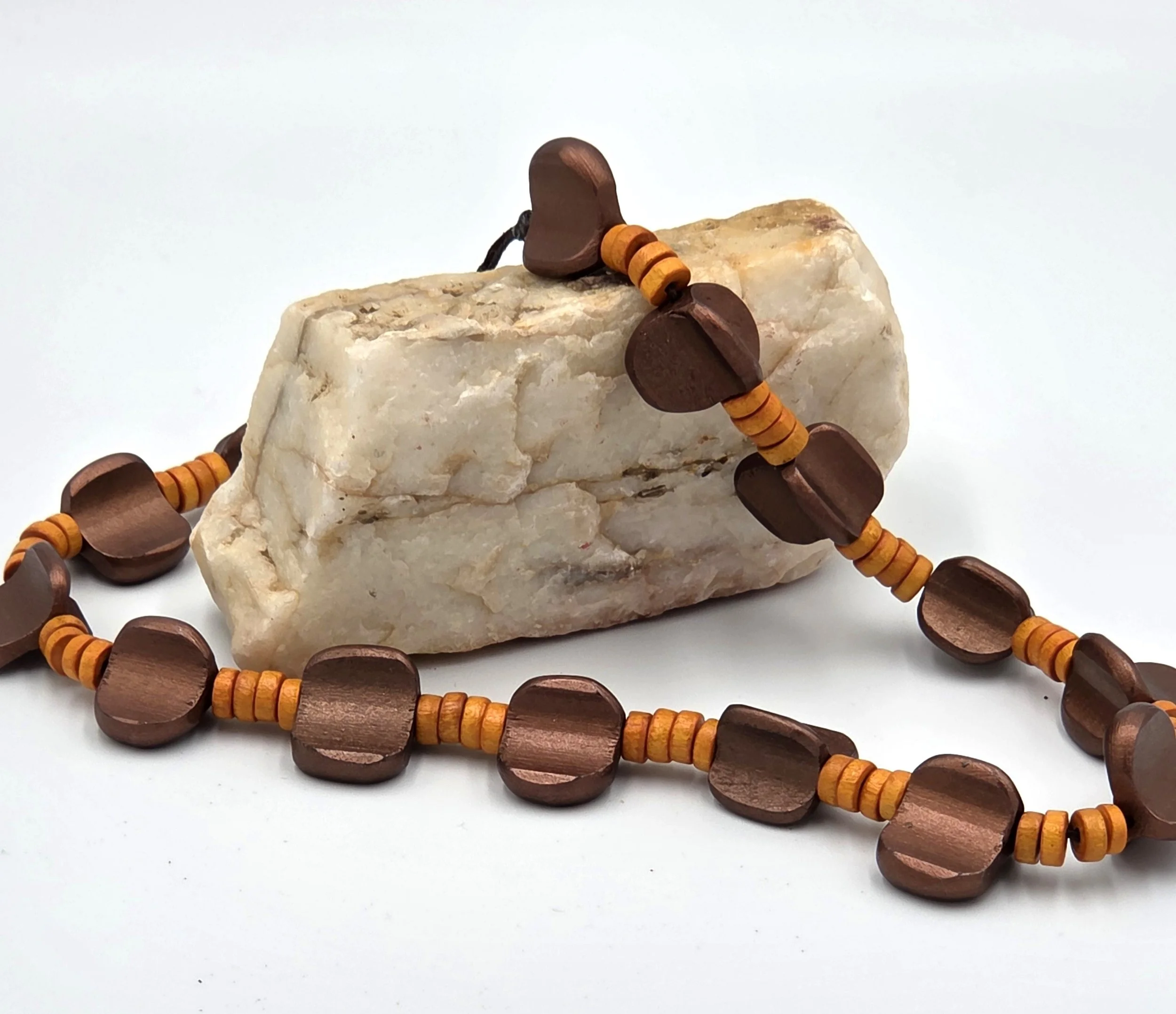 Bronze asymmetric wood beads and orange disc beads on a 48cm necklace.