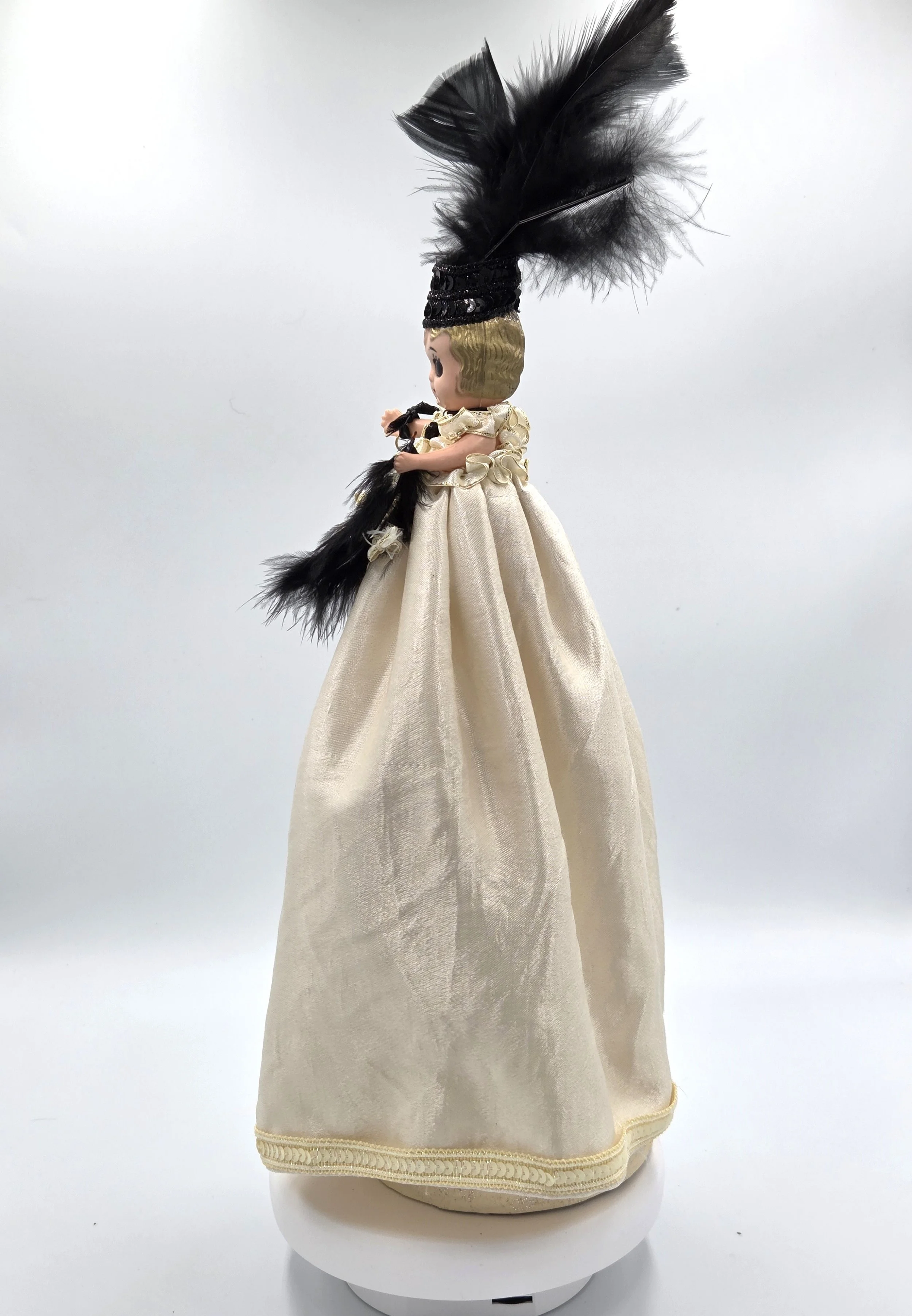 side view Sabina Art Doll Black and ivory themed doll with feathers, sequins and dangling beads