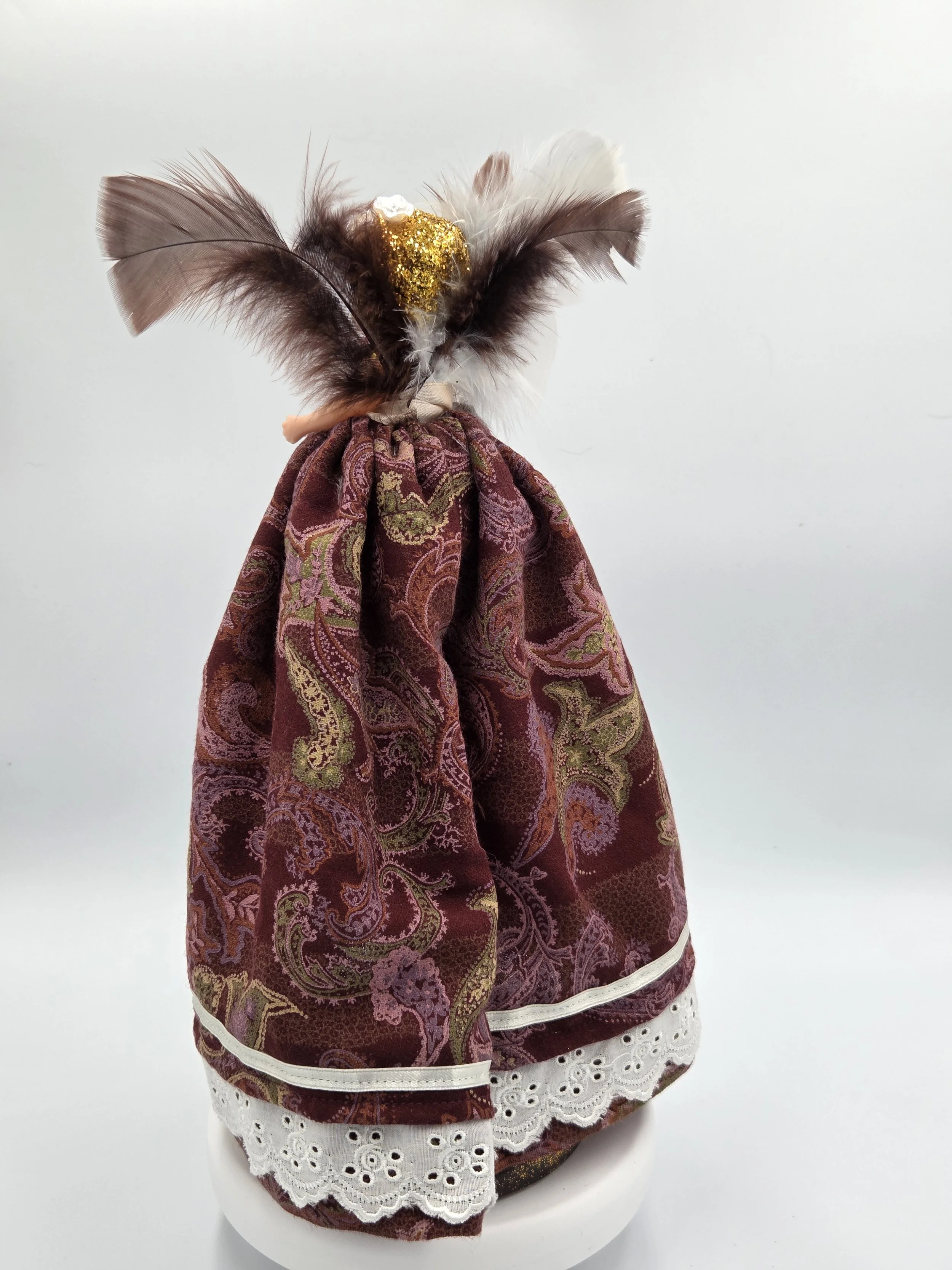 Rear view showing the lush texture of the brown and cream-grey feathers.