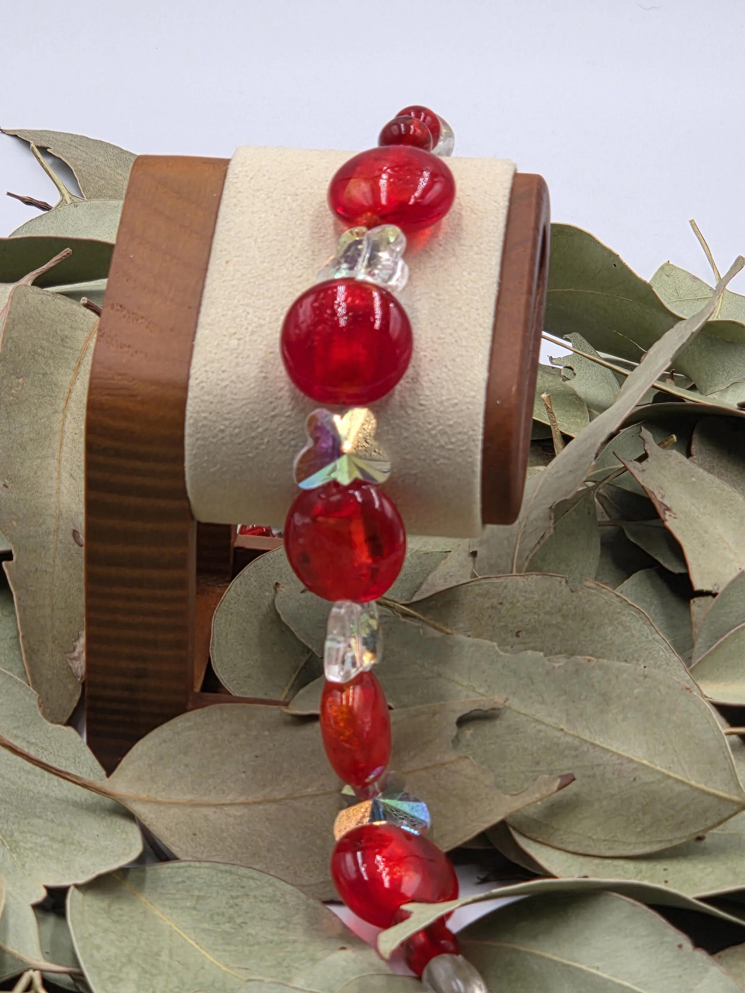 Red lampwork glass oval necklace with clear quartz nuggets, AB glass butterflies, silver flower toggle, and matching earrings.