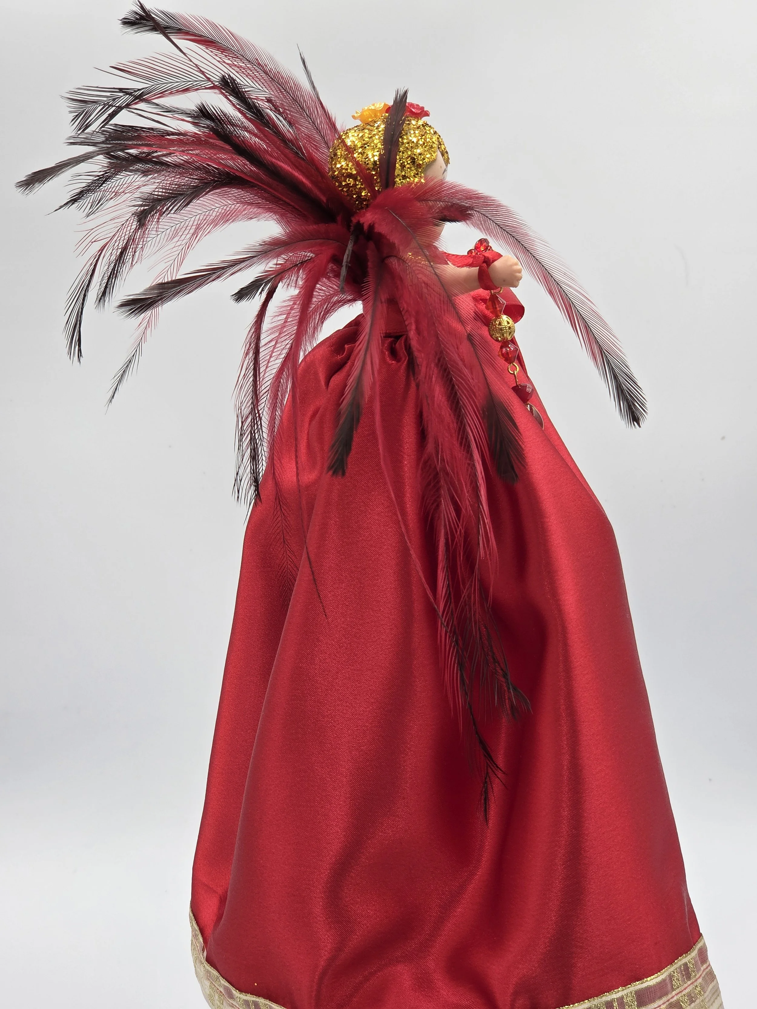 OOAK 33cm red satin art doll with a dramatic red and black feather backdrop on a red wooden stand.