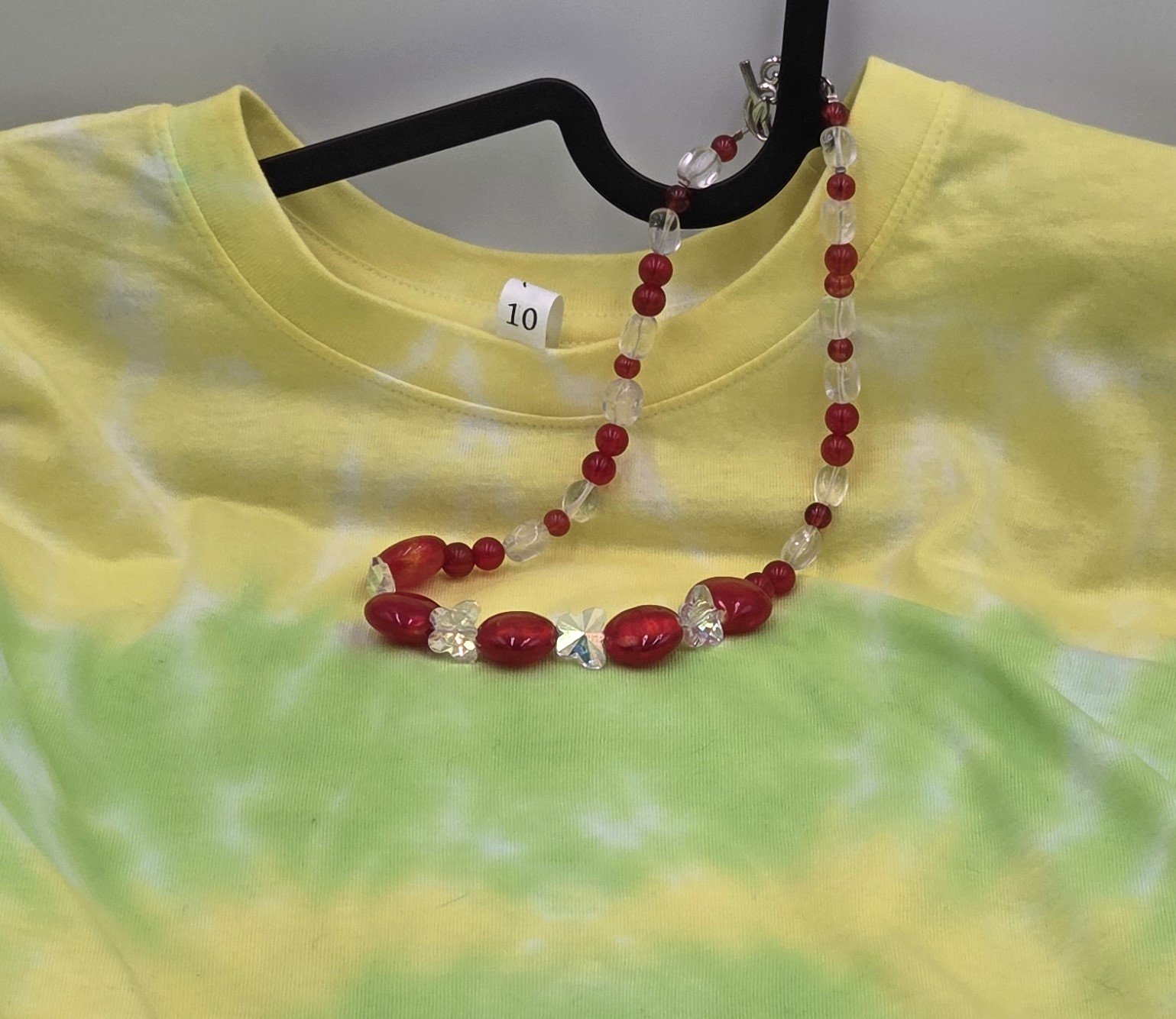 Red lampwork glass oval necklace with clear quartz nuggets, AB glass butterflies, silver flower toggle, and matching earrings.