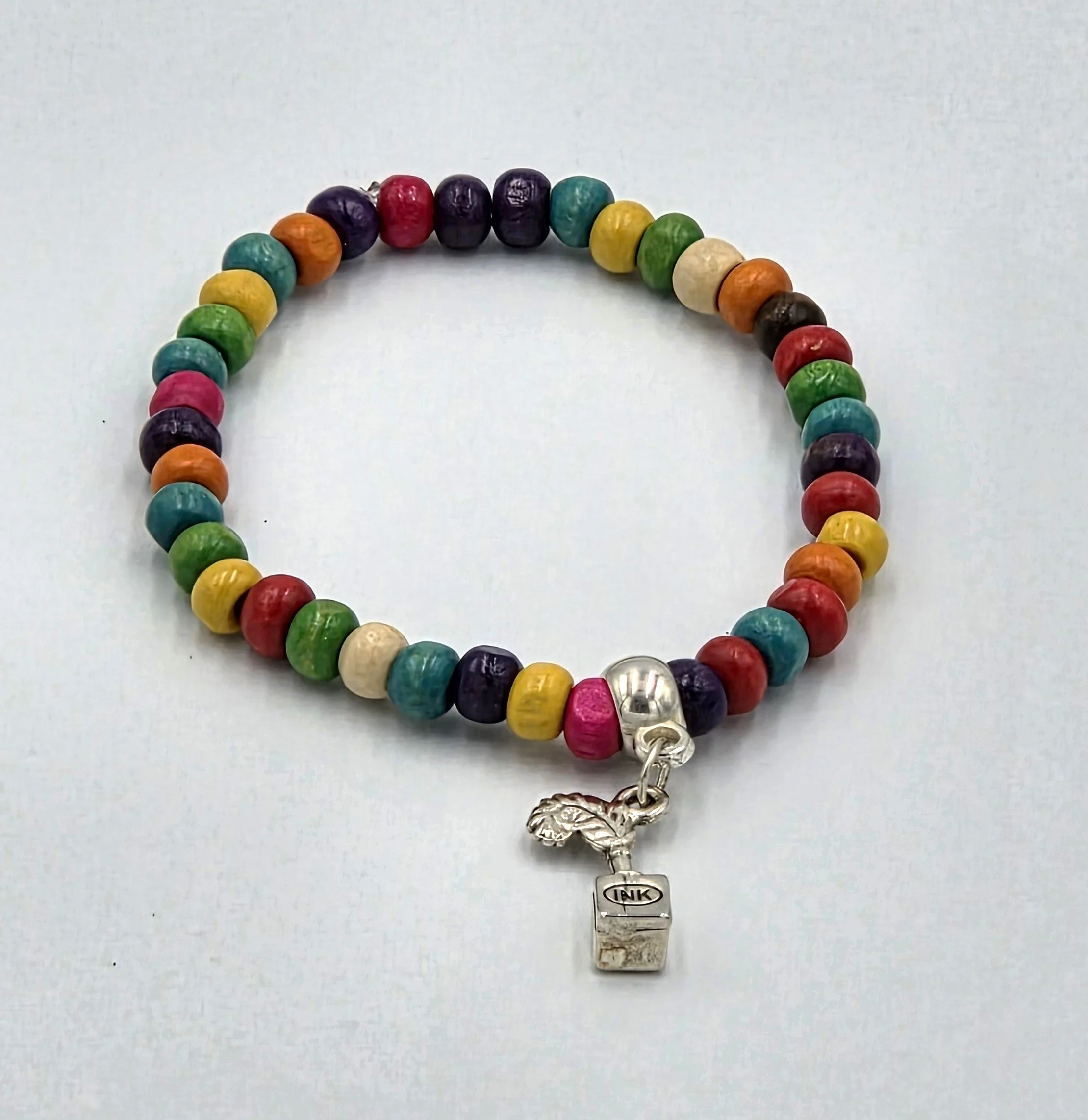 OOAK multicolored wood bead bracelet with silver quill pen and ink stand charm.