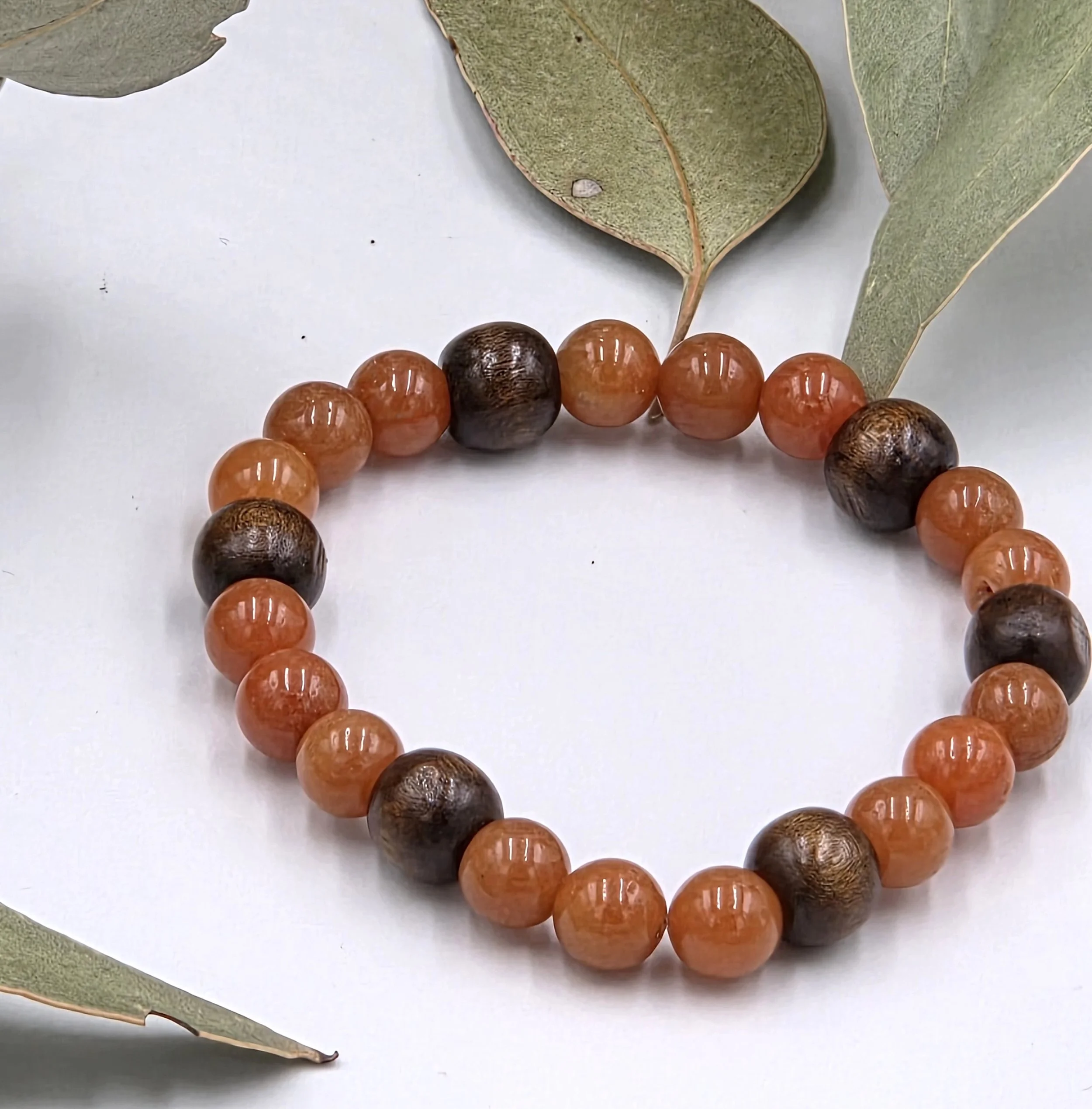 Warm red aventurine beads combined with dark brown wood beads on a classic elastic bracelet.