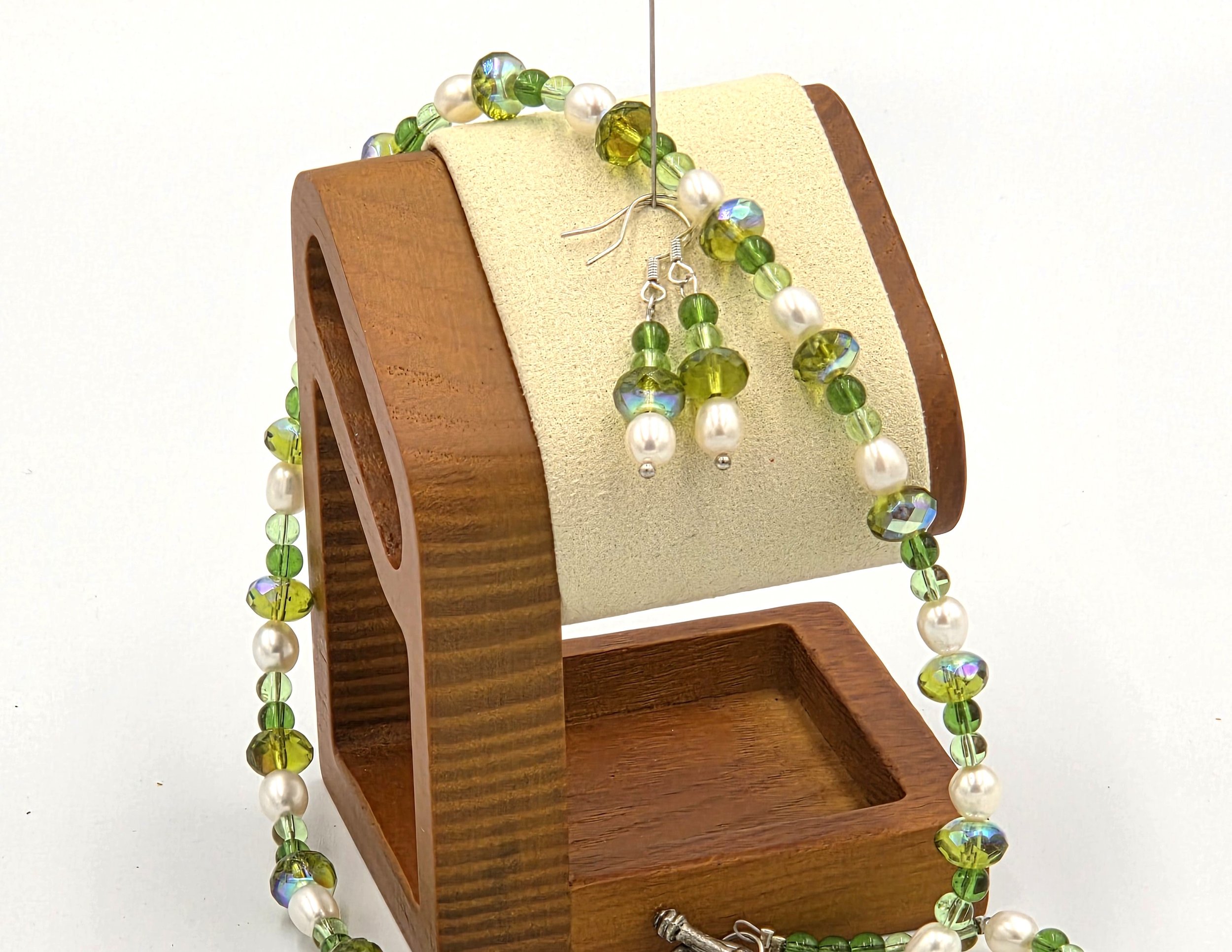 close up of Long pearl and sparkling lime green crystal necklace with matching earrings.