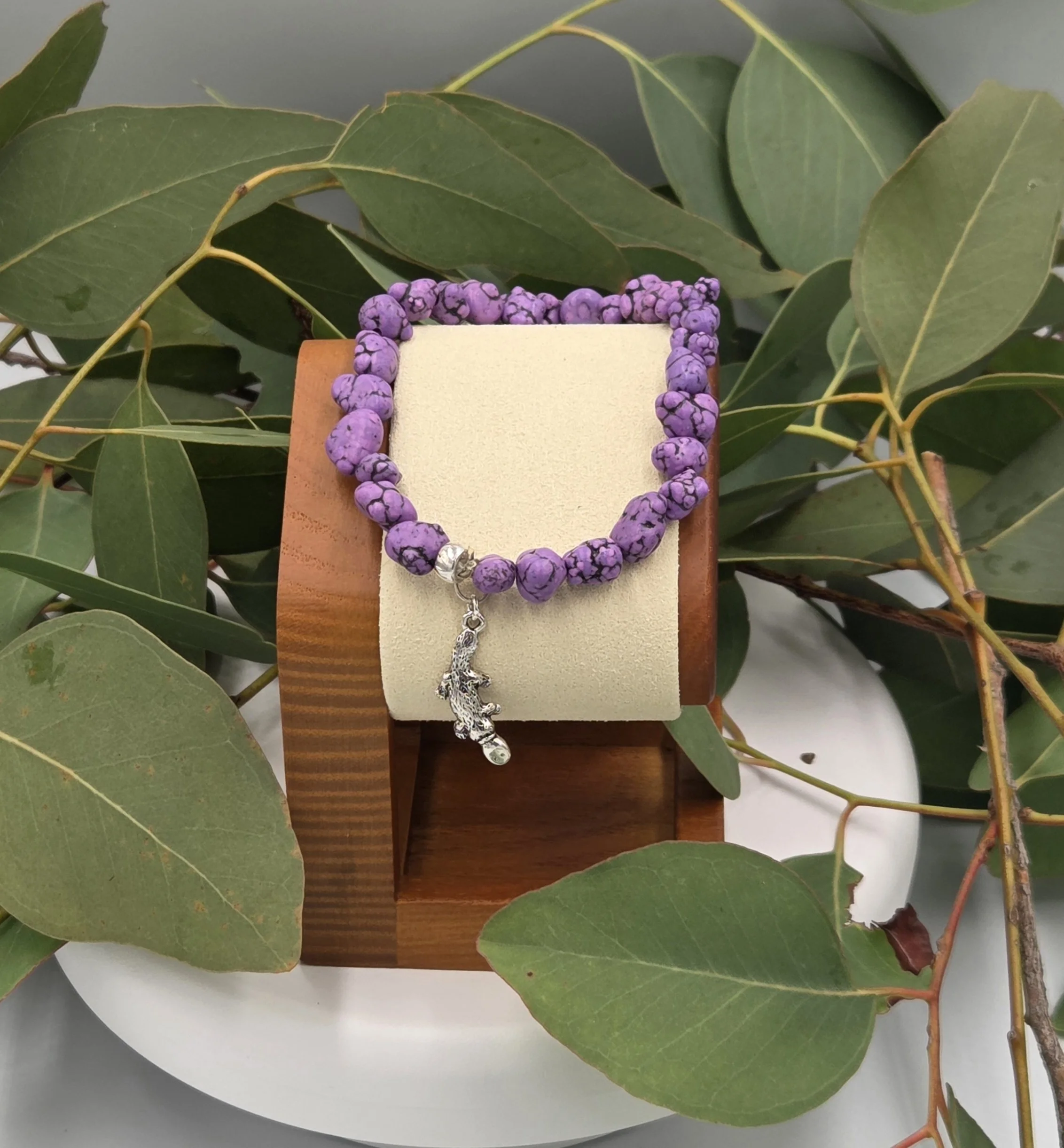 OOAK purple Howlite nugget bracelet with silver platypus charm with background of gum leaves