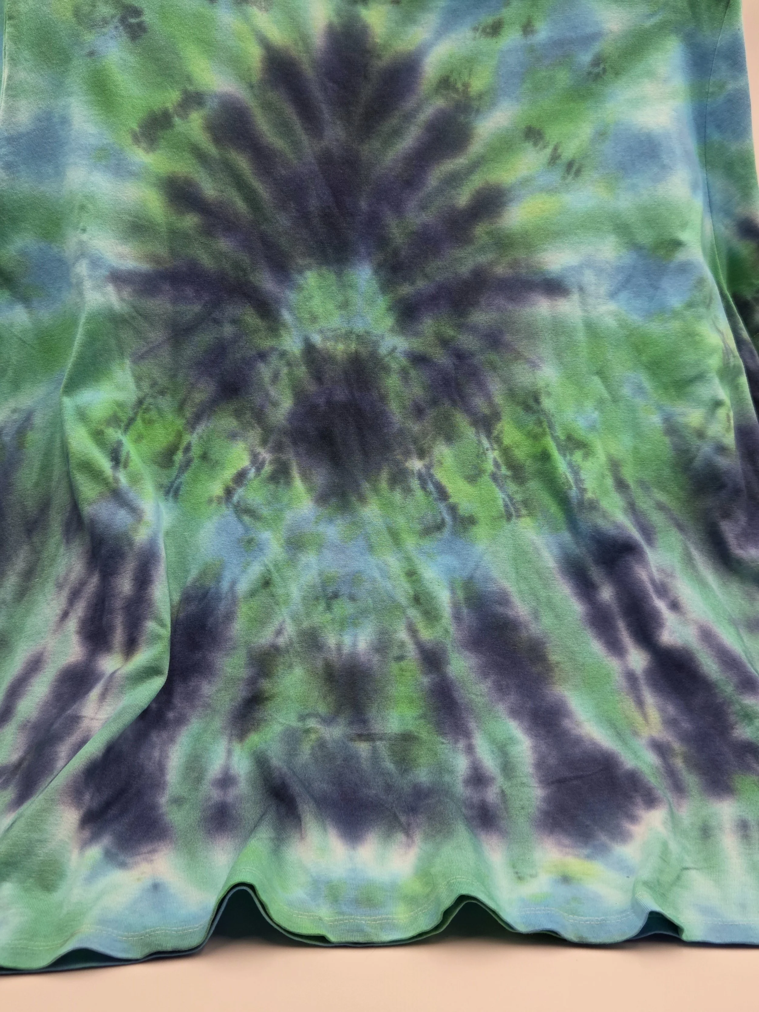 Size 20 adult hand-dyed t-shirt with a dark blue burst and spray pattern over pastel aquamarine. OOAK wearable art by Livity Studio."
