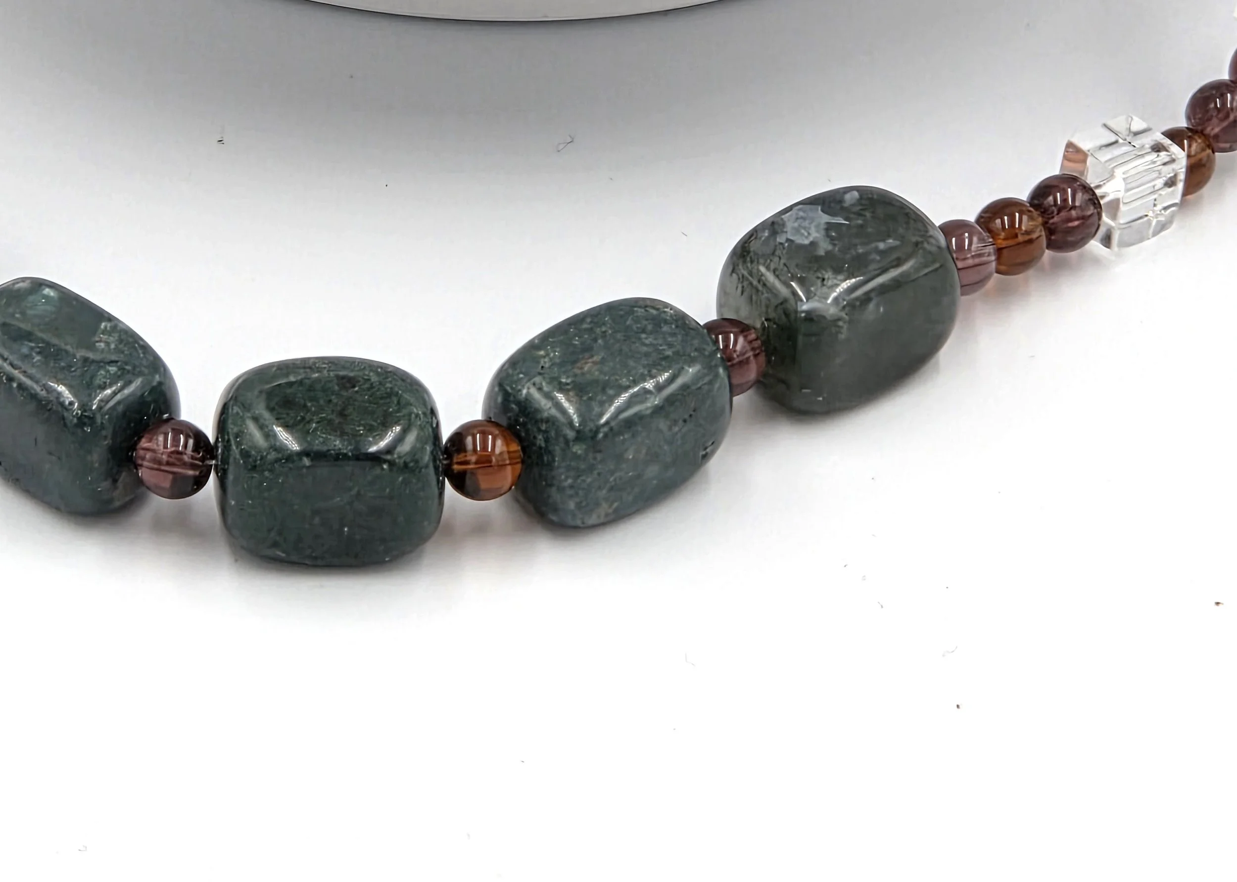 Large Moss Agate nuggets framed by dark amber glass beads and clear glass squares on a silver toggle necklace.
