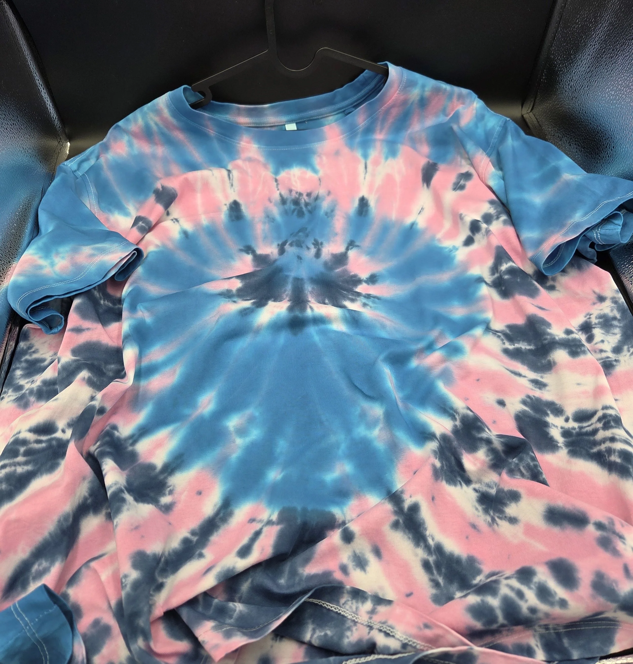 Women's size 22 hand-dyed cotton T-shirt with a blue and pink twist pattern resembling a large flower bloom. OOAK wearable art by Livity Studio."