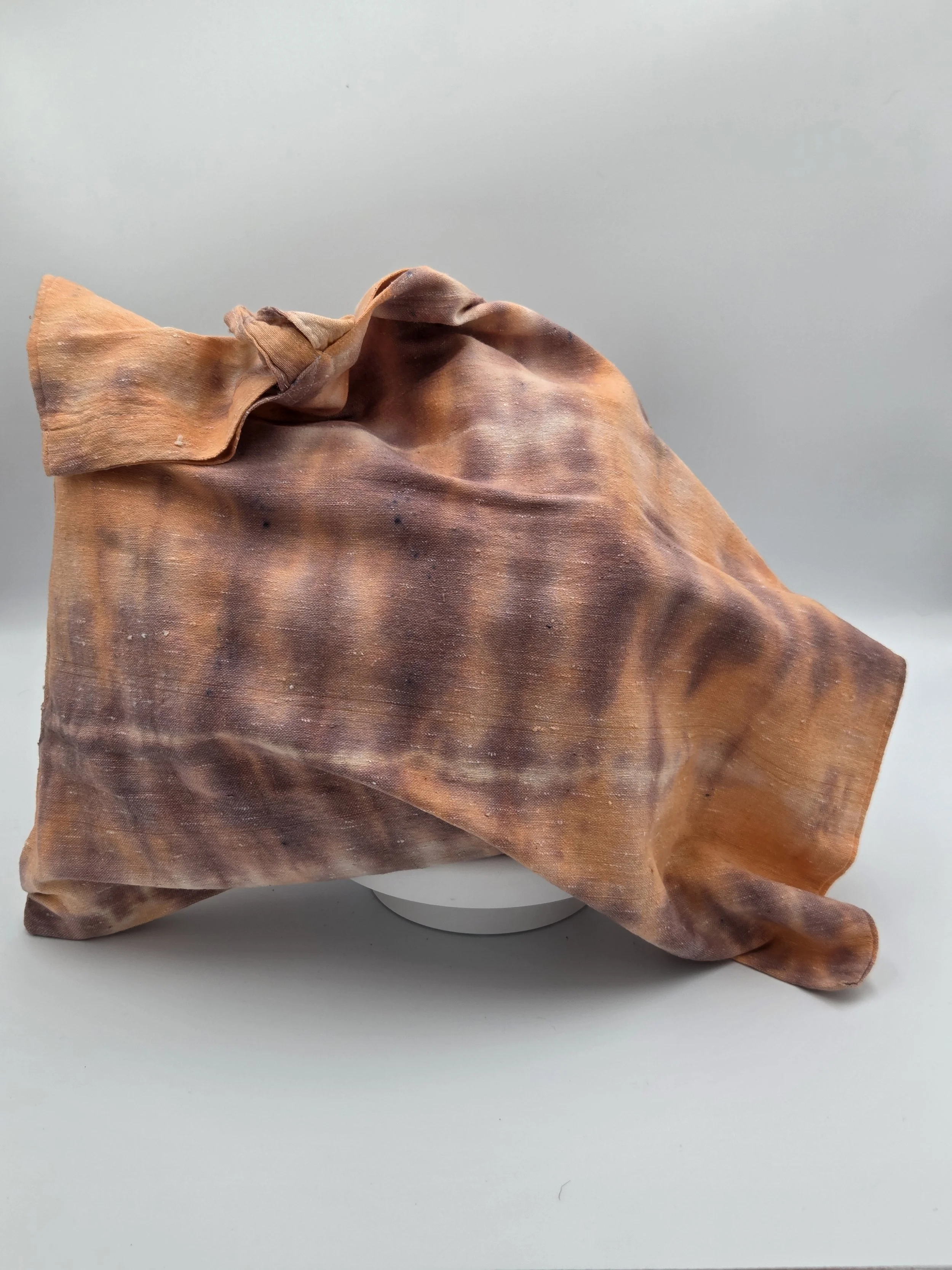 Hand-dyed calico cotton tote bag with a faded horizontal rainfall pattern in light brown and pastel orange. OOAK textile art by Livity Studio.