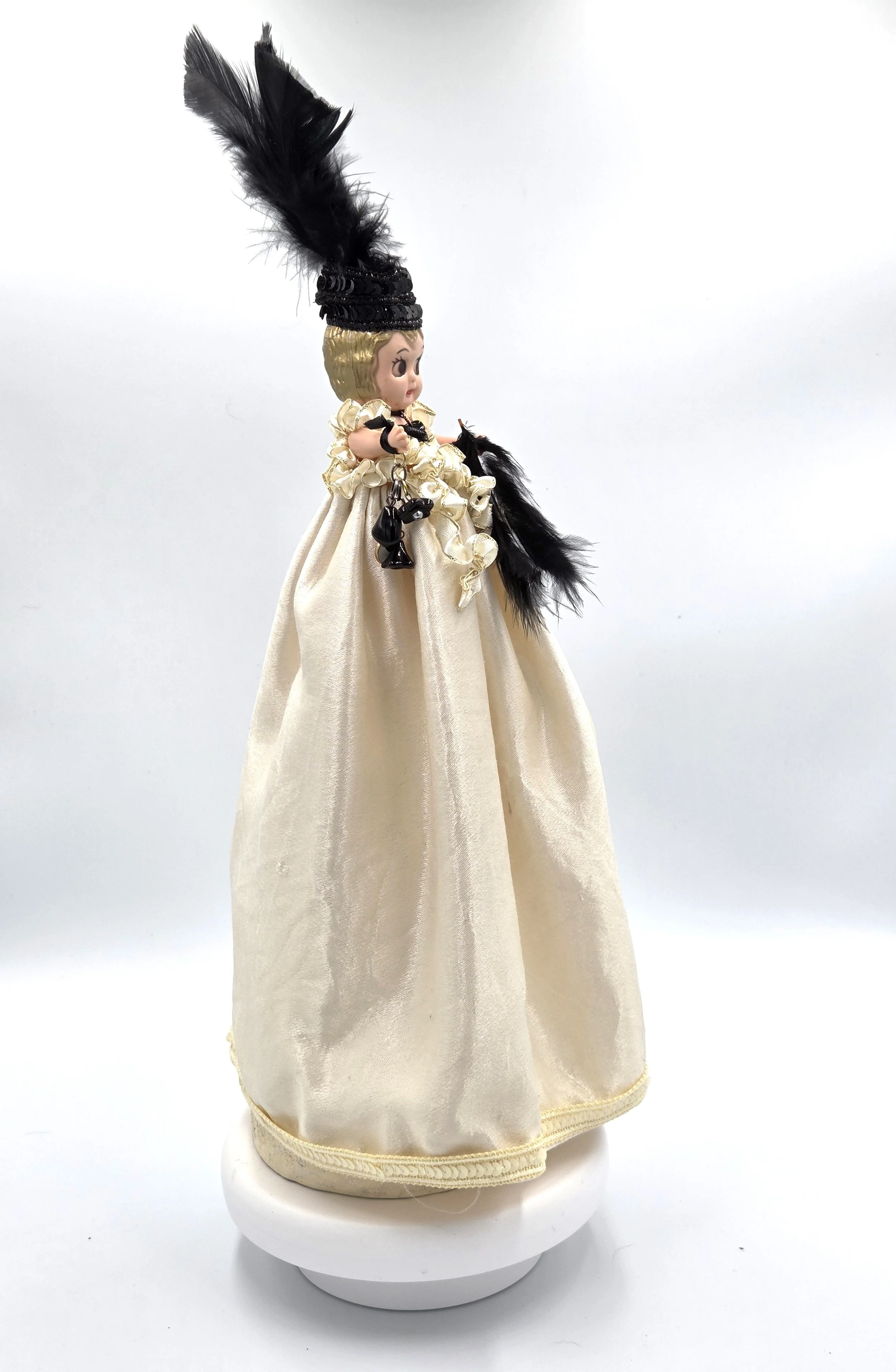 side view Sabina Art Doll Black and ivory themed doll with feathers, sequins and dangling beads