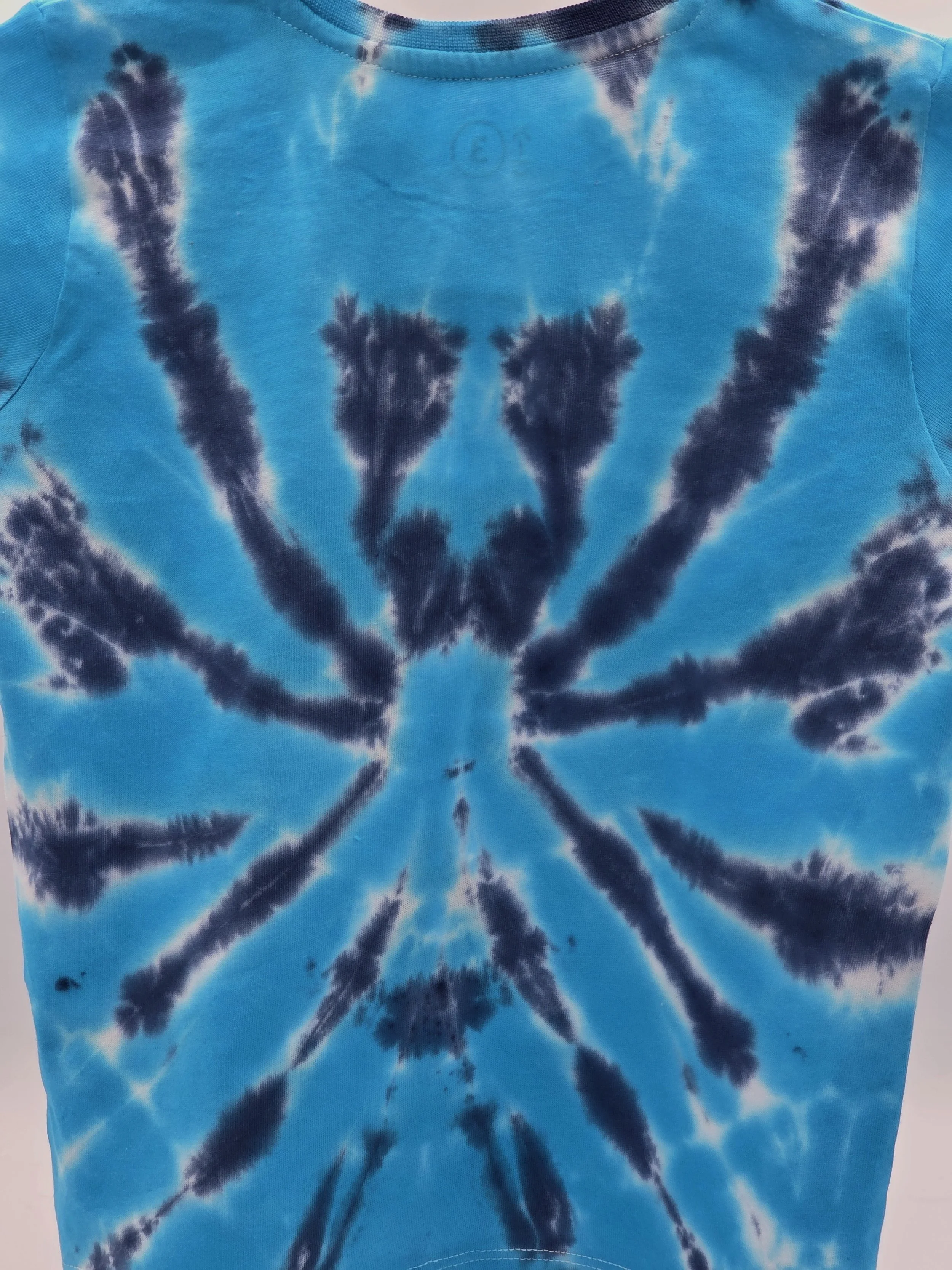 child size 3 cotton t-shirt featuring a dark blue tie-dye spider pattern against a bright turquoise background.