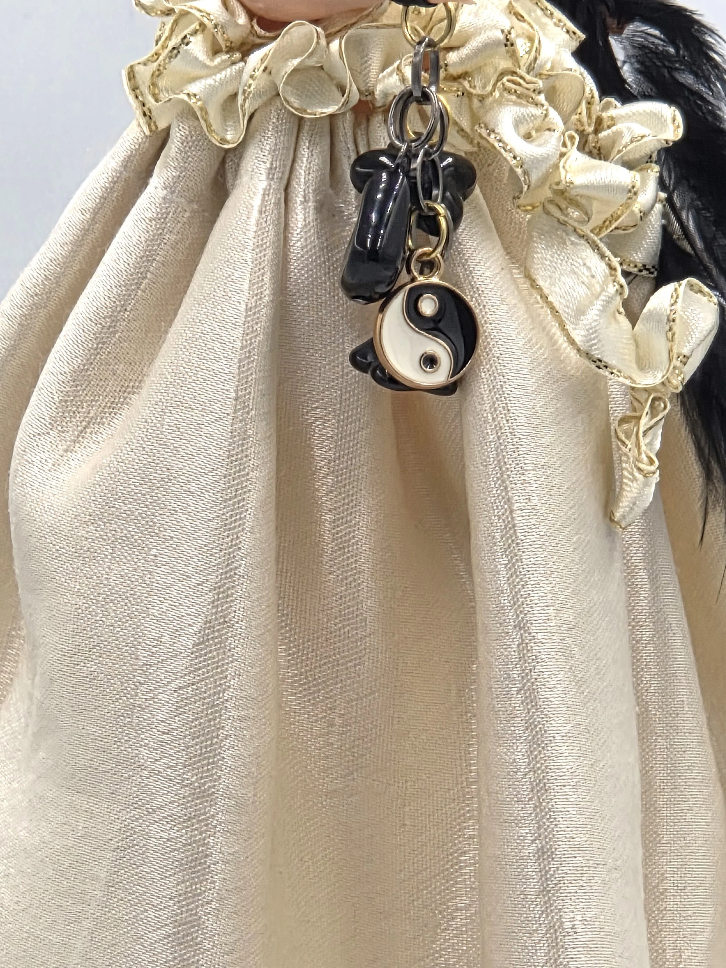 close up of dangling beads includiing yin yang symbol