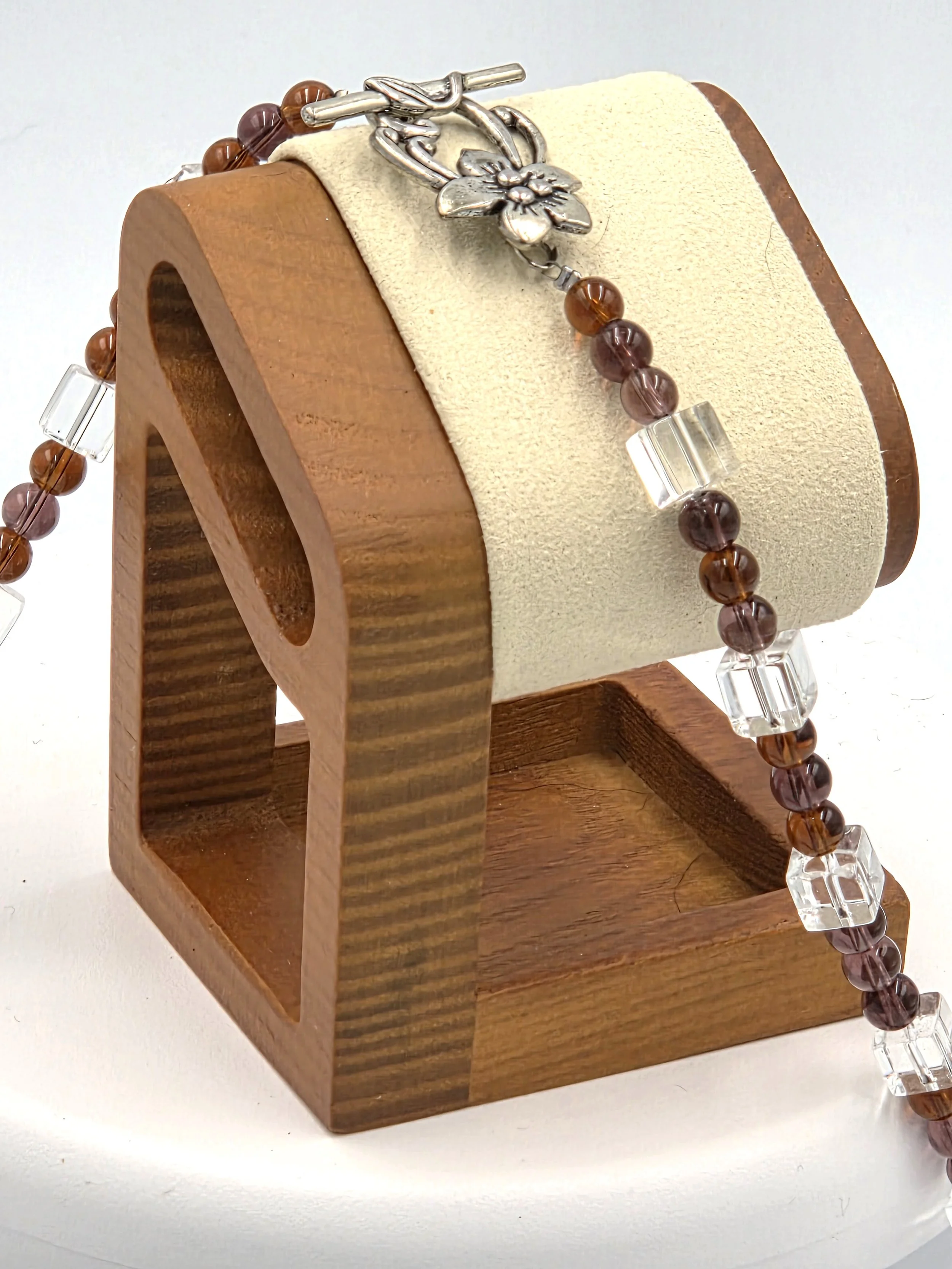 Large Moss Agate nuggets framed by dark amber glass beads and clear glass squares on a silver toggle necklace.
