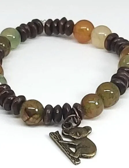close up of Genuine Dragon vein Agate and wood on elastic with bronze Koala charm