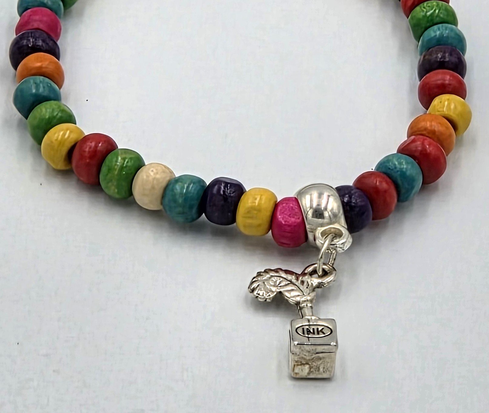 OOAK multicolored wood bead bracelet with silver quill pen and ink stand charm.