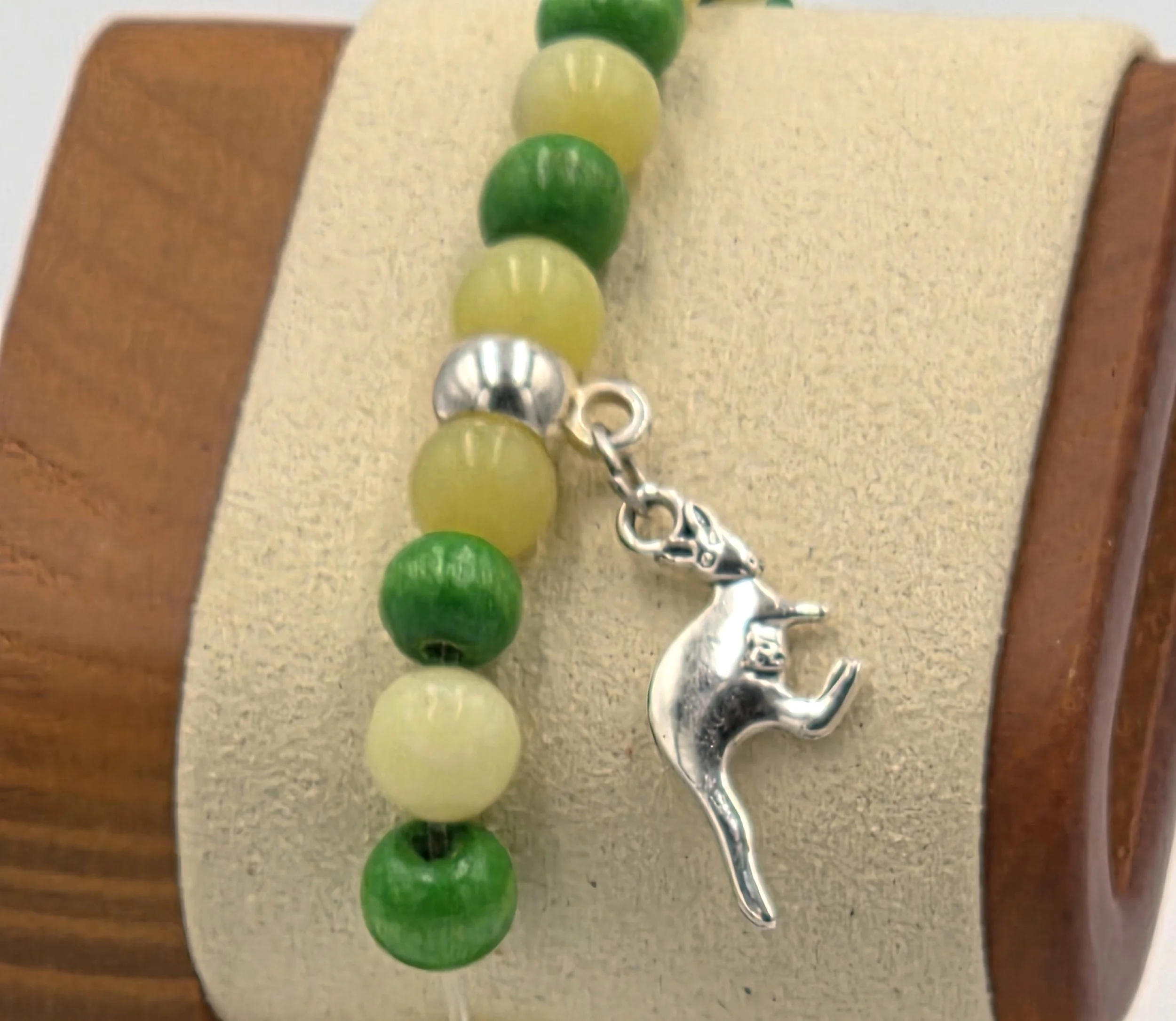 close up of OOAK lemon agate and green wood bracelet with silver kangaroo charm.