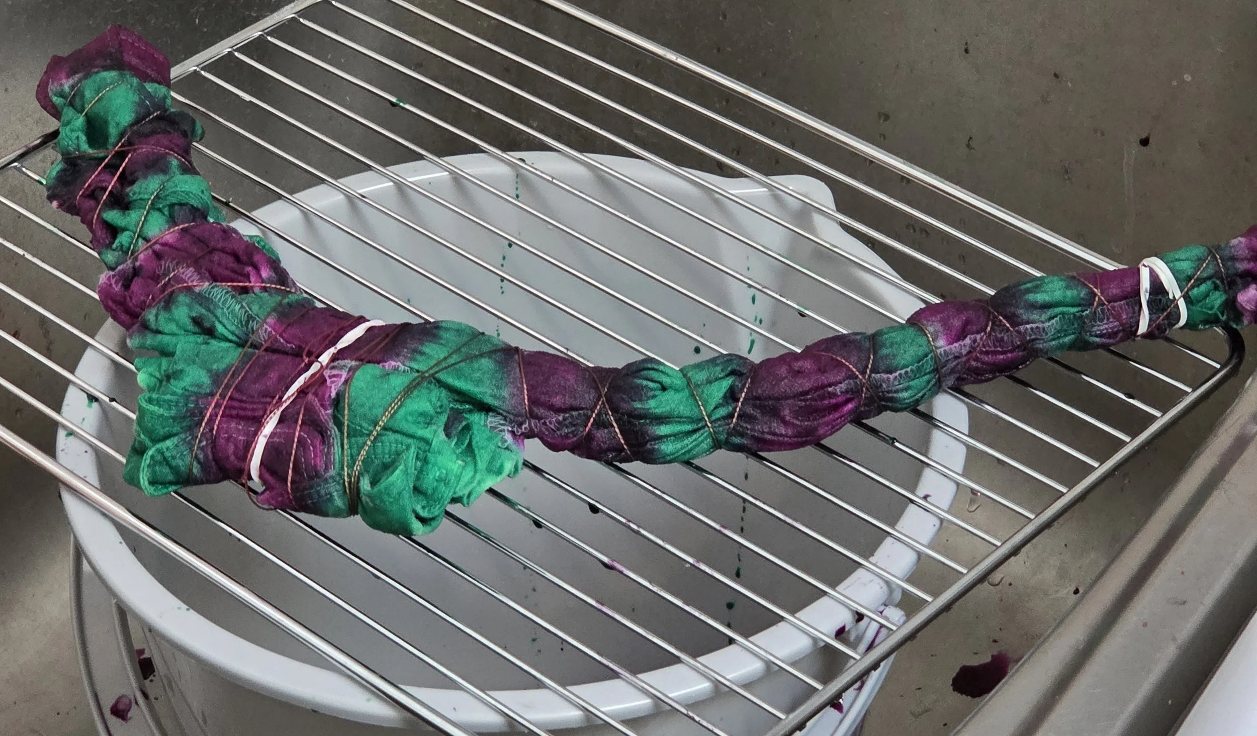showing a child's shirt tie dye process, tied up in vertical fold pattern