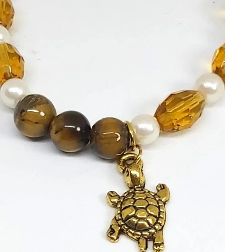 close up Tiger's eye gemstone beads with Amber glass faceted beads with turtle charm on elastic