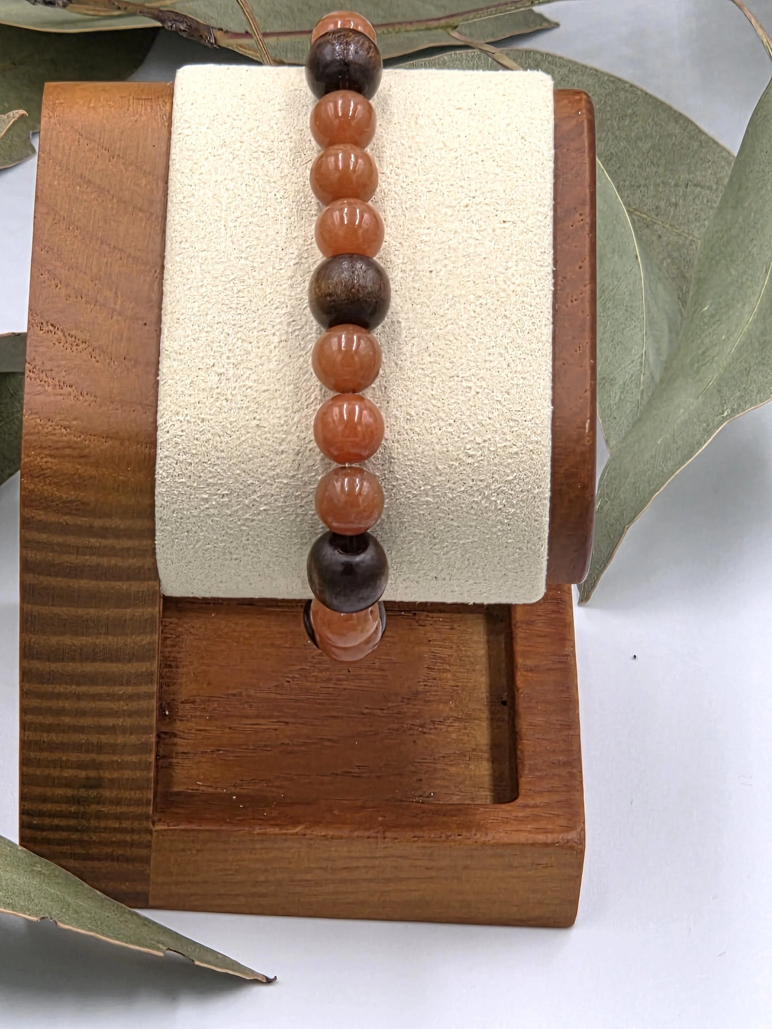 Warm red aventurine beads combined with dark brown wood beads on a classic elastic bracelet.