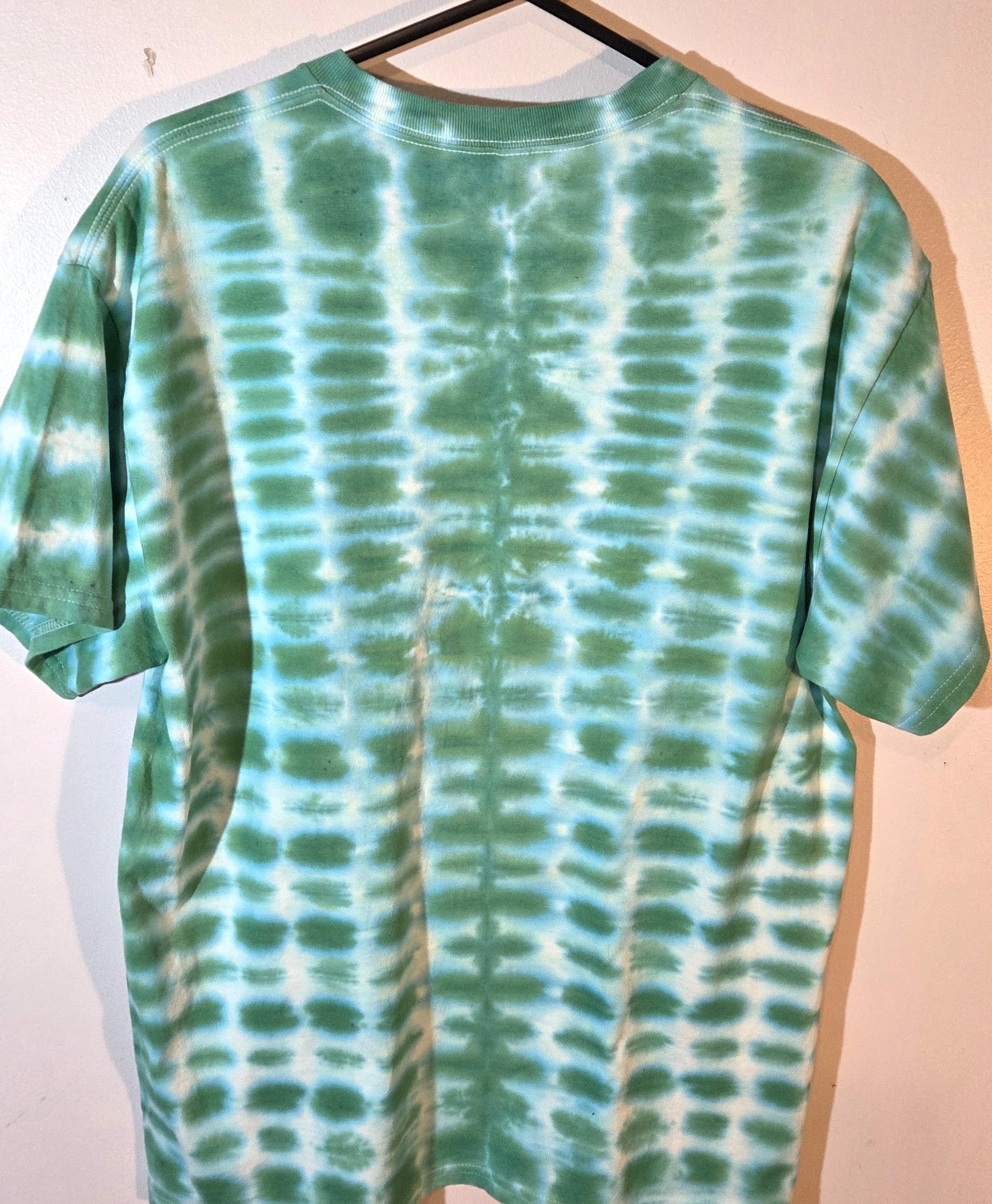 back view of A large adult green and white t-shirt featuring a highly regular tie-dye pattern resembling green bricks in a wall.
