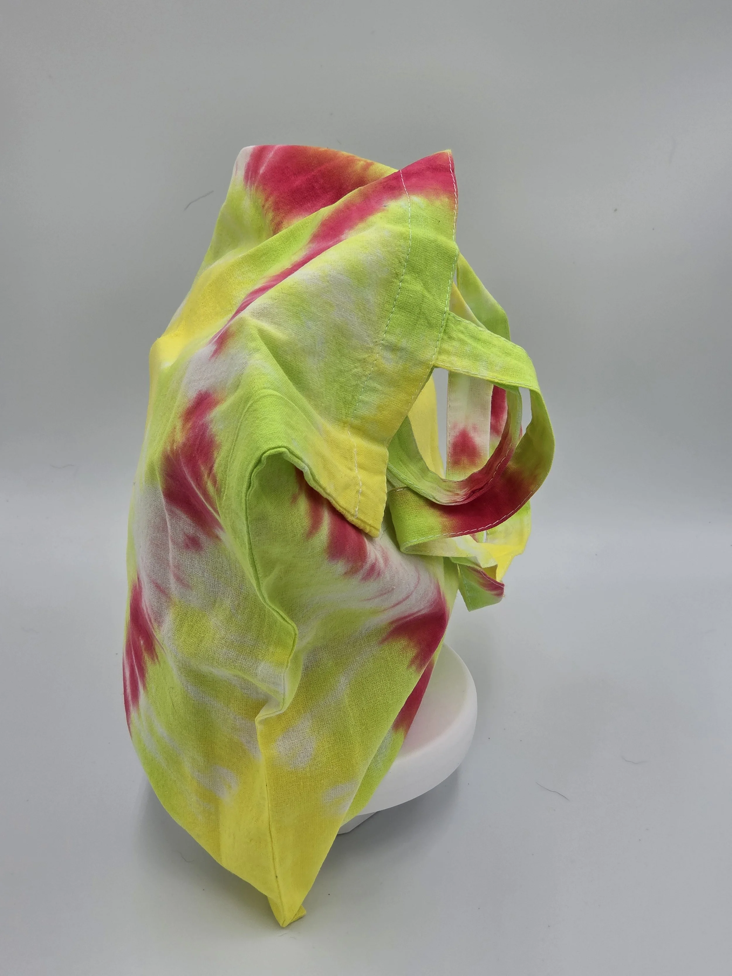 Hand-dyed cotton tote bag with a fuchsia diamond center on a lime and yellow background. OOAK textile art by Livity Studio.