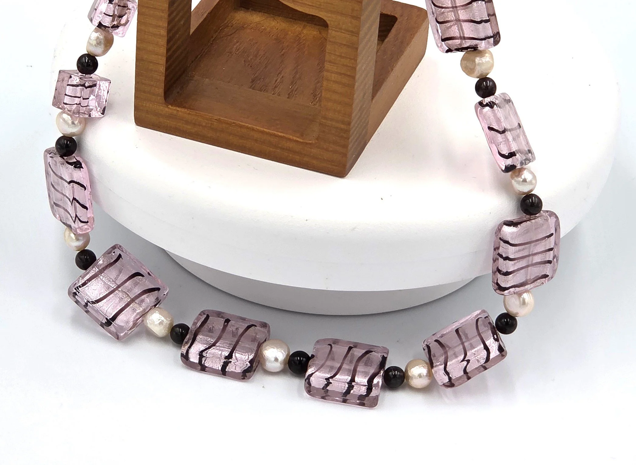 Pink and black striped silver-foil glass rectangles with pink freshwater pearls and red garnet beads on an adjustable silver clasp necklace.