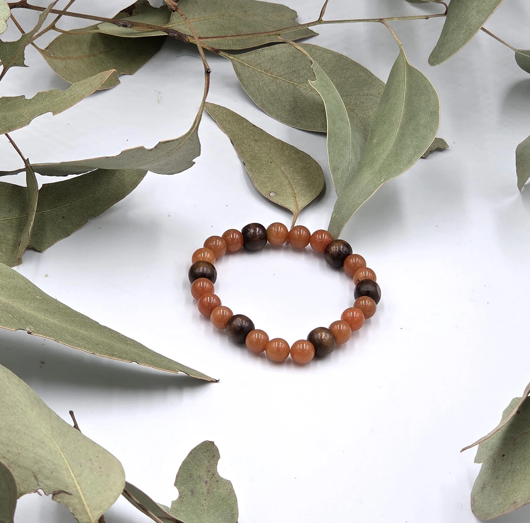 Warm red aventurine beads combined with dark brown wood beads on a classic elastic bracelet.