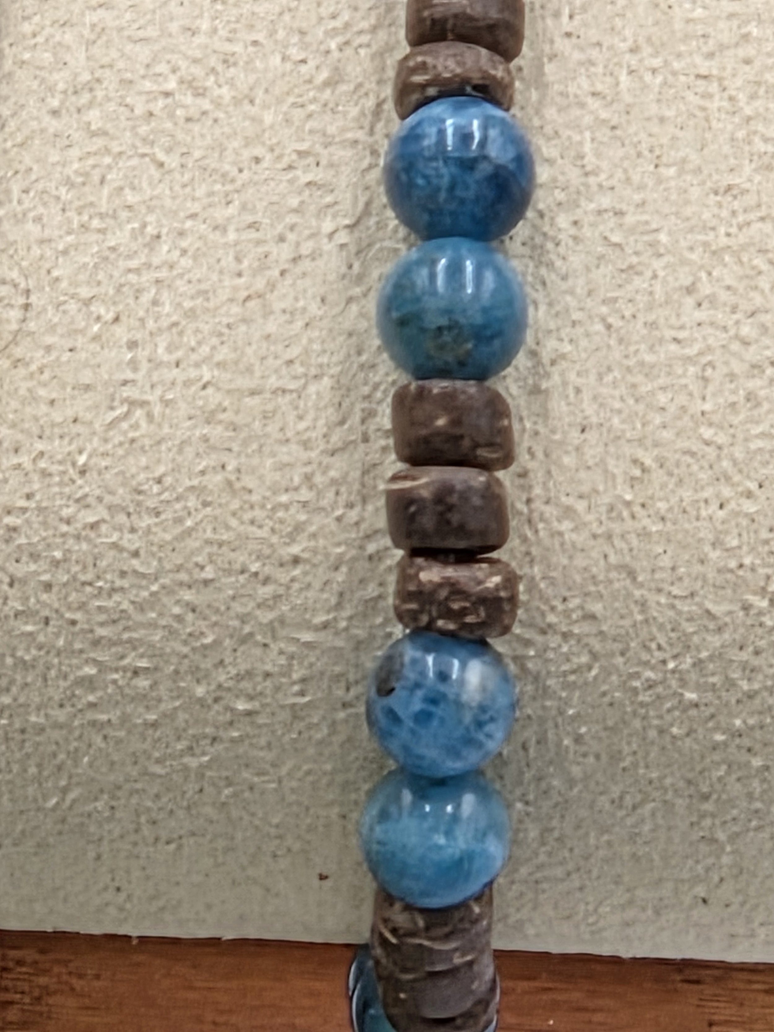 close up of OOAK blue apatite and small brown coconut disc elastic bracelet.