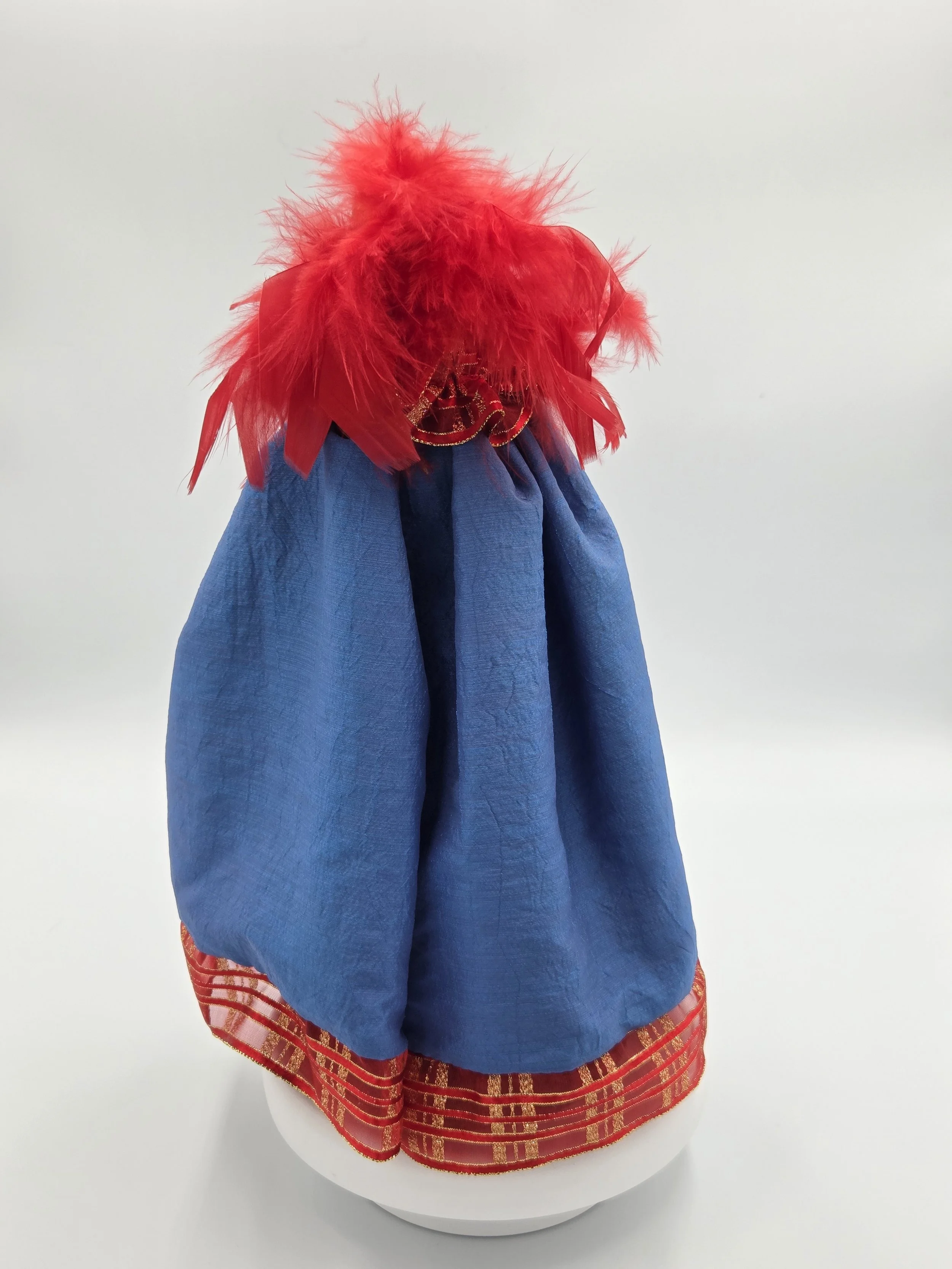 back view of Antheia doll in sea-blue taffeta with golden butterfly and red feathers.