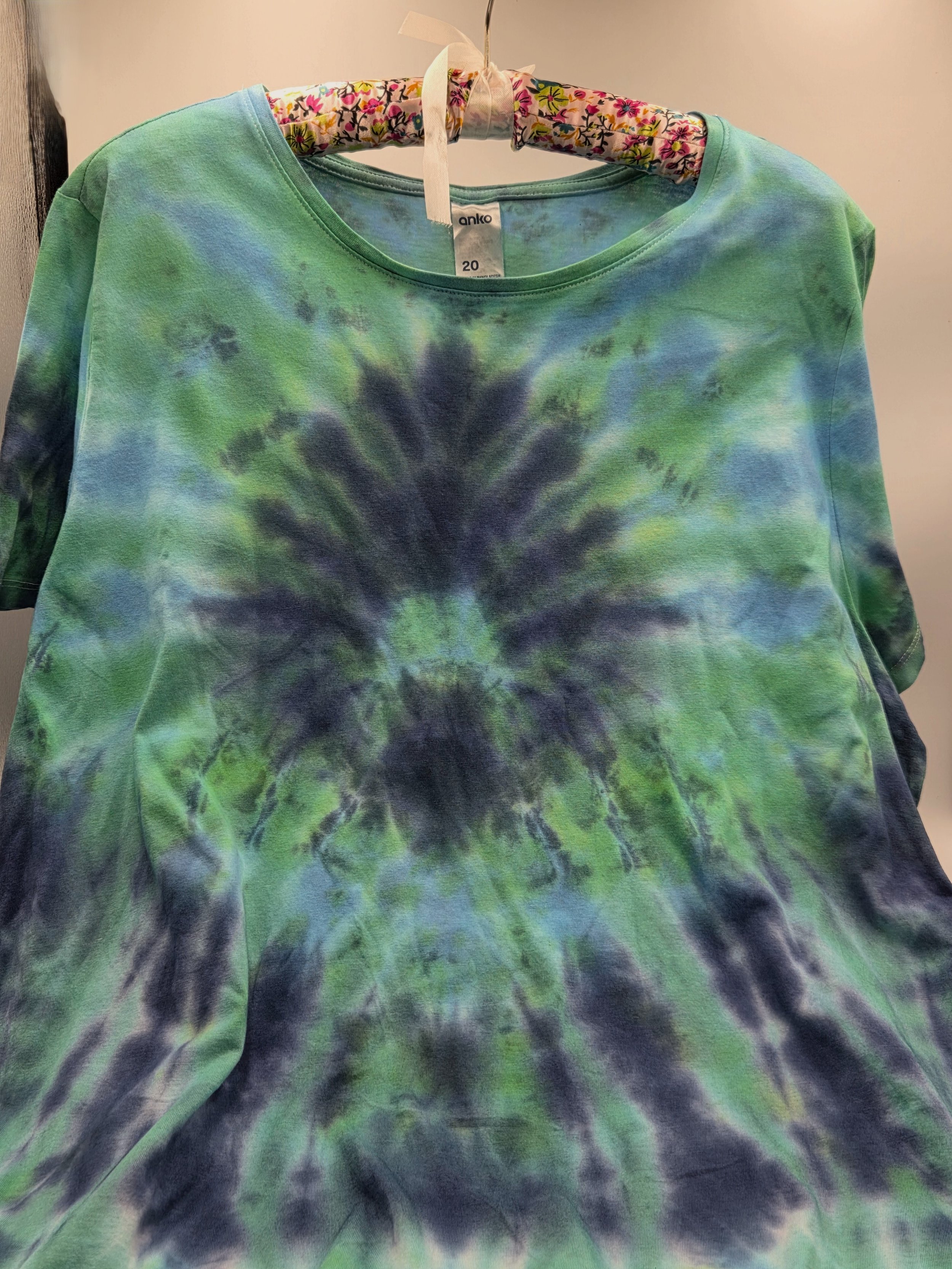 Size 20 adult hand-dyed t-shirt with a dark blue burst and spray pattern over pastel aquamarine. OOAK wearable art by Livity Studio."
