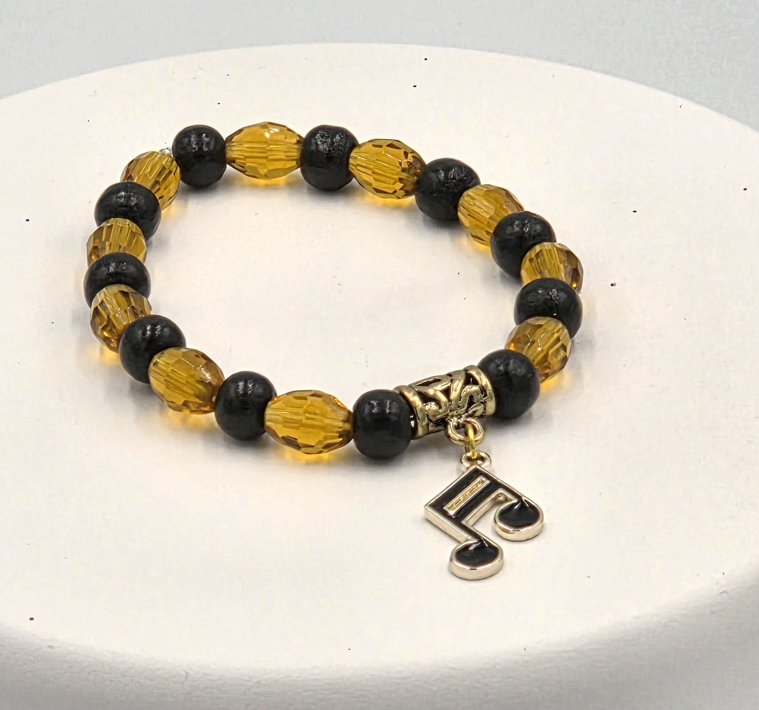 OOAK amber glass and black wood bracelet with gold & black musical note charm.