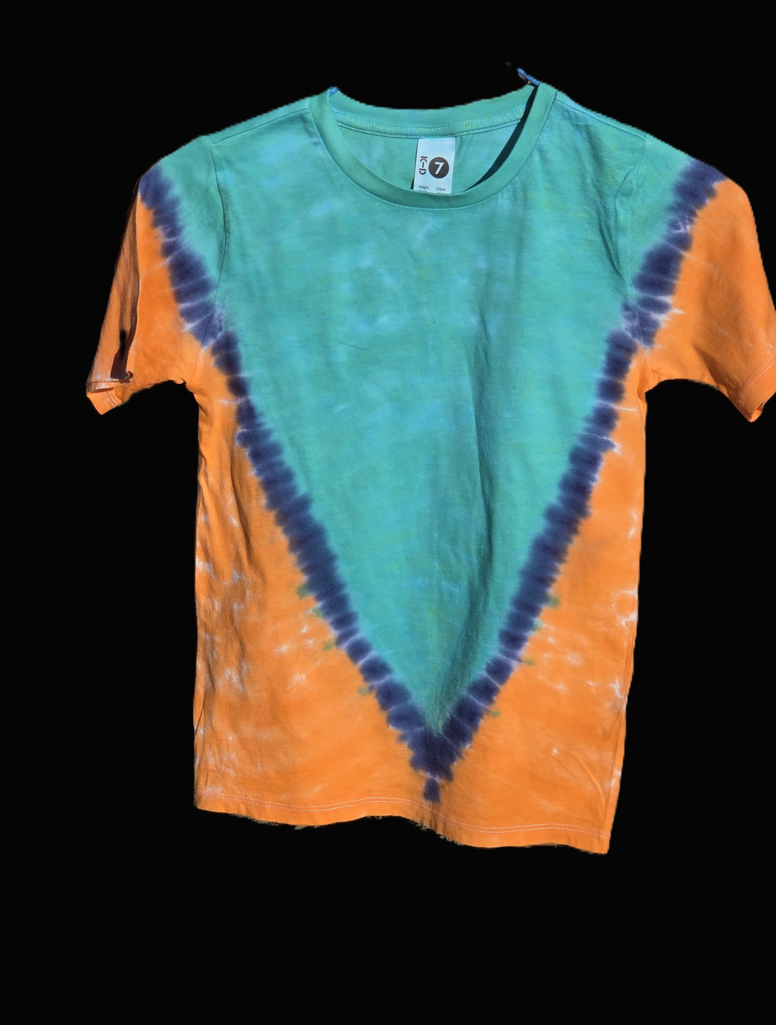 A child size 7 cotton t-shirt featuring a large teal and dark blue V-shape tie-dye pattern against a bright orange background.