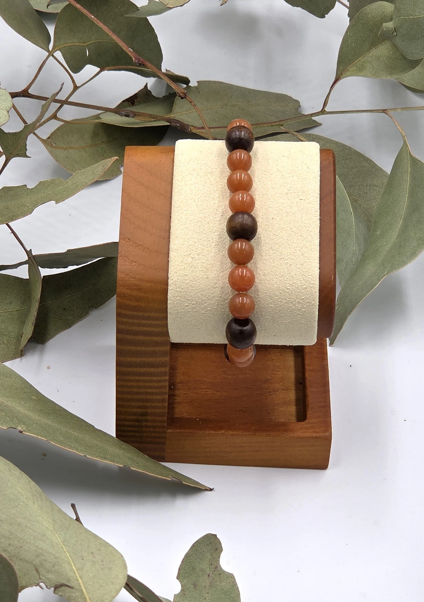 Warm red aventurine beads combined with dark brown wood beads on a classic elastic bracelet.