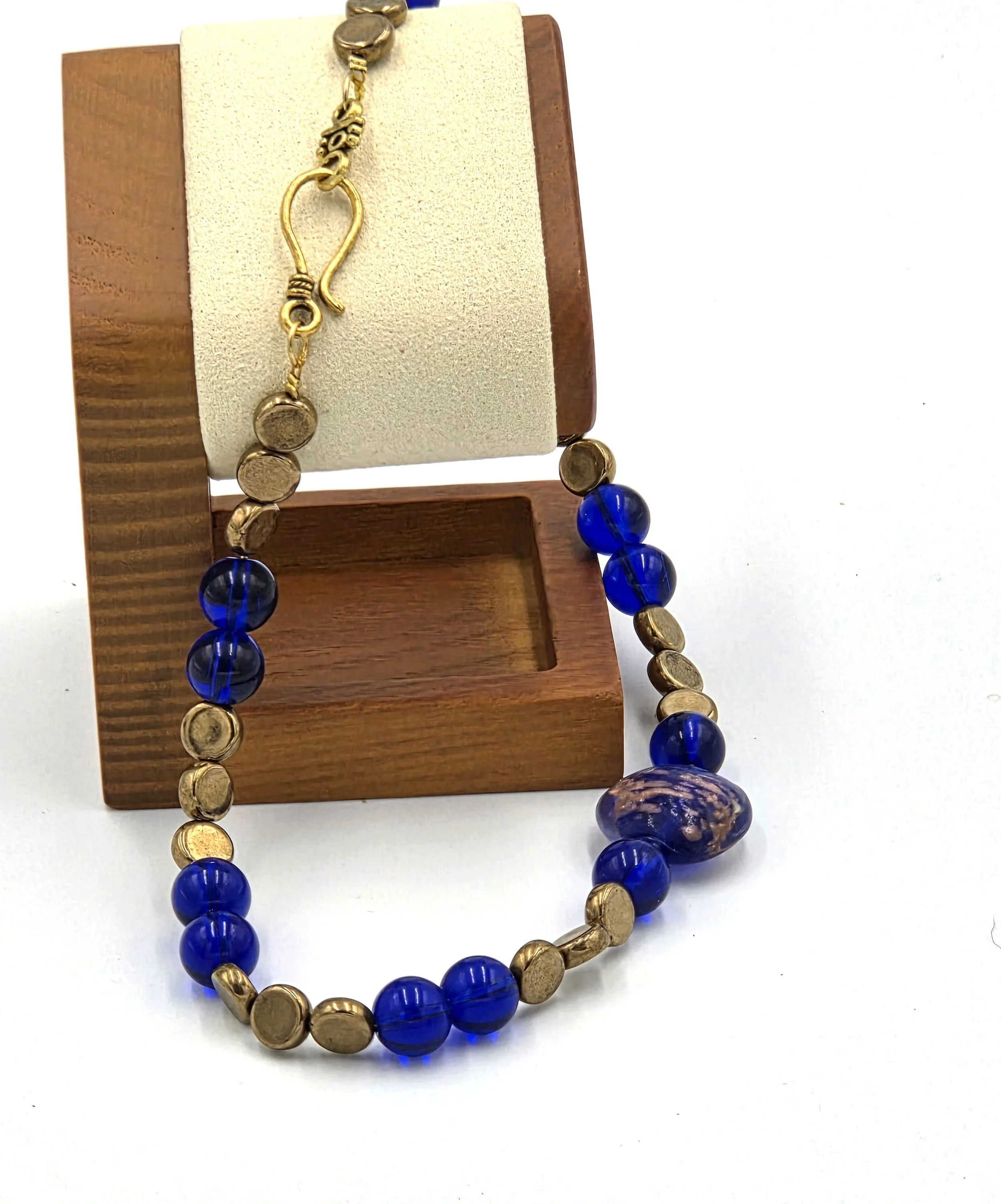 Dark blue and gold choker necklace with a large gold-foil glass bead