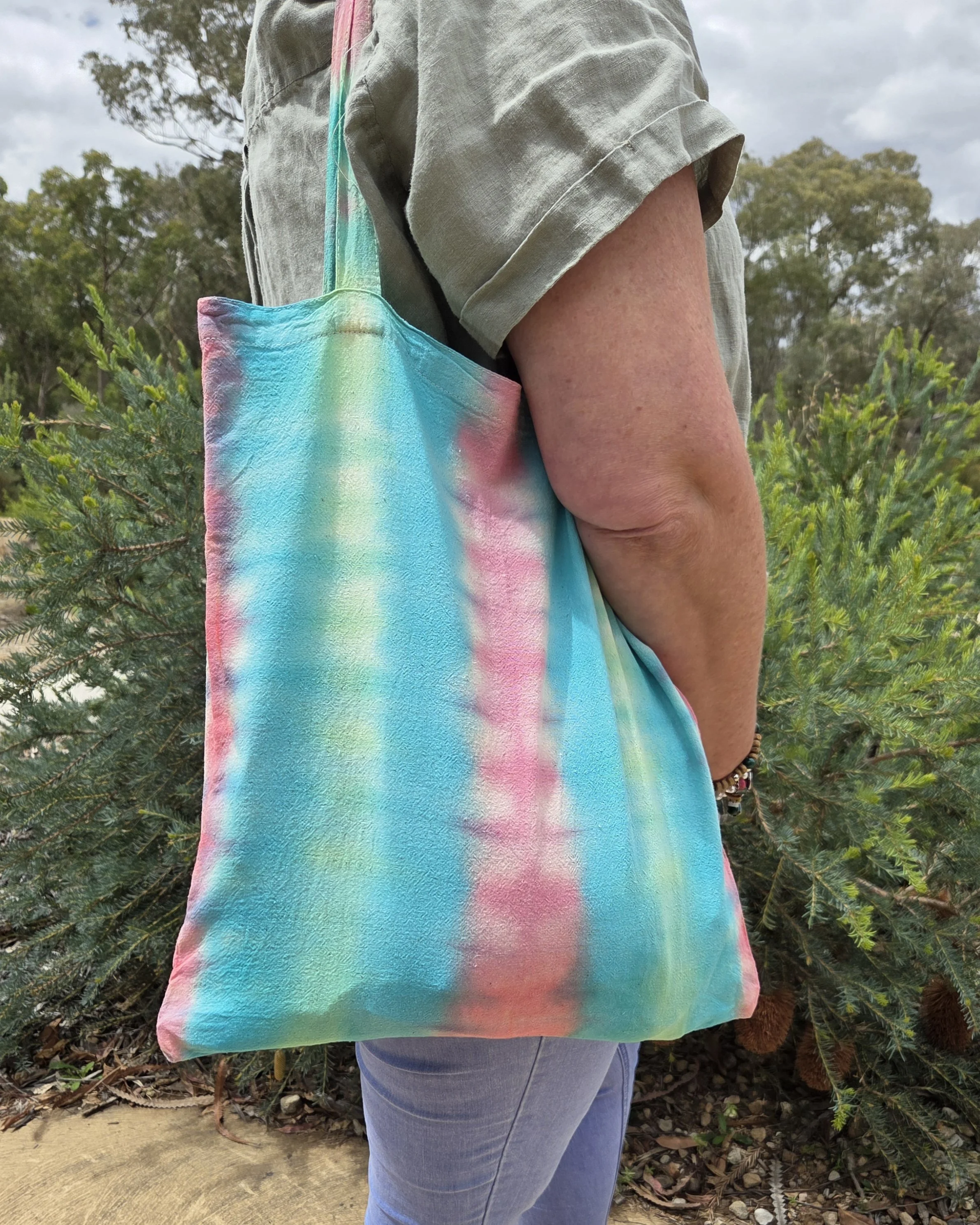"Hand-dyed calico cotton tote bag with vertical pastel bands of bubblegum pink, teal, and lime green. One-of-a-kind textile art by Livity Studio Canberra."
