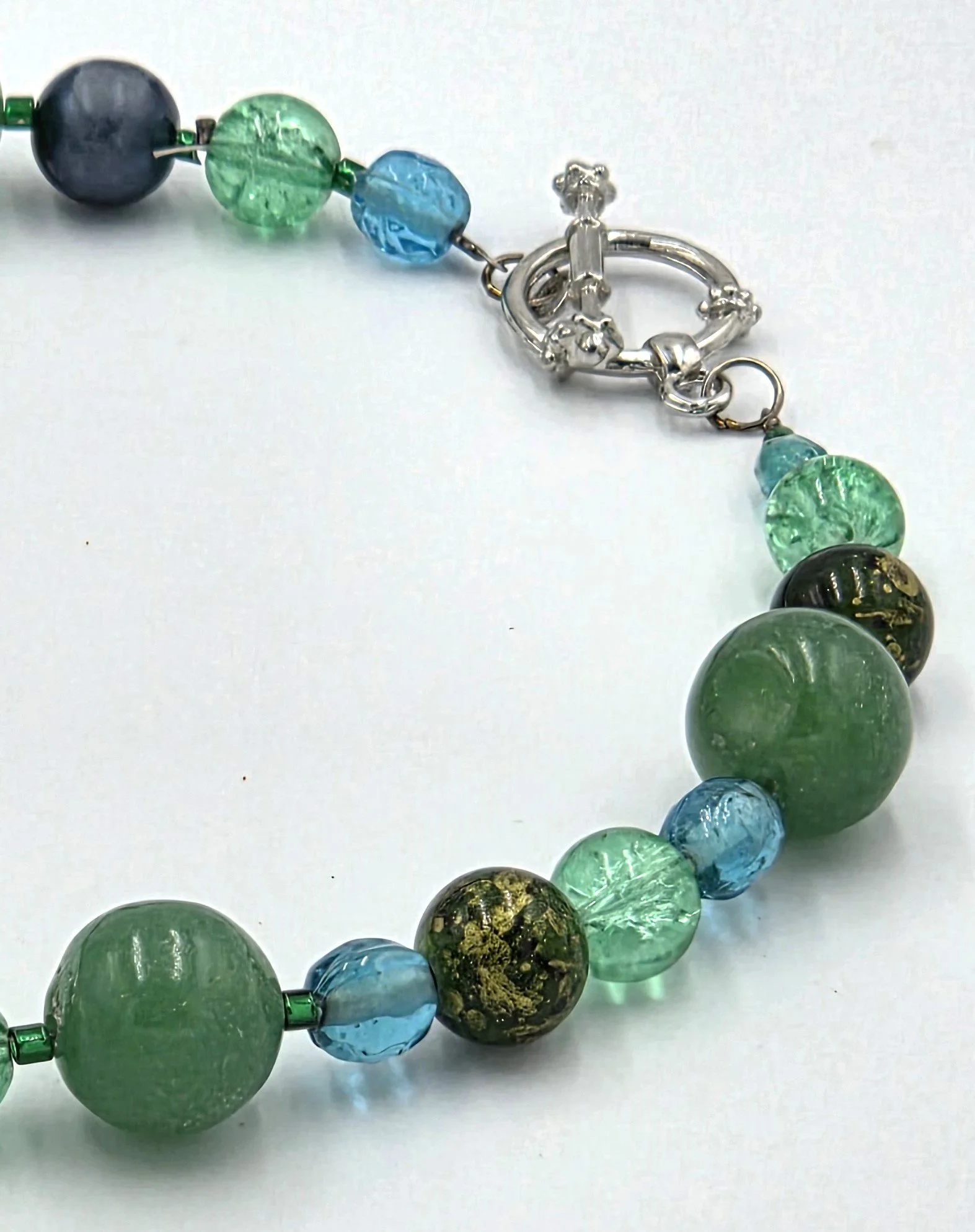 Green choker necklace with matte agate and sparkling glass beads.