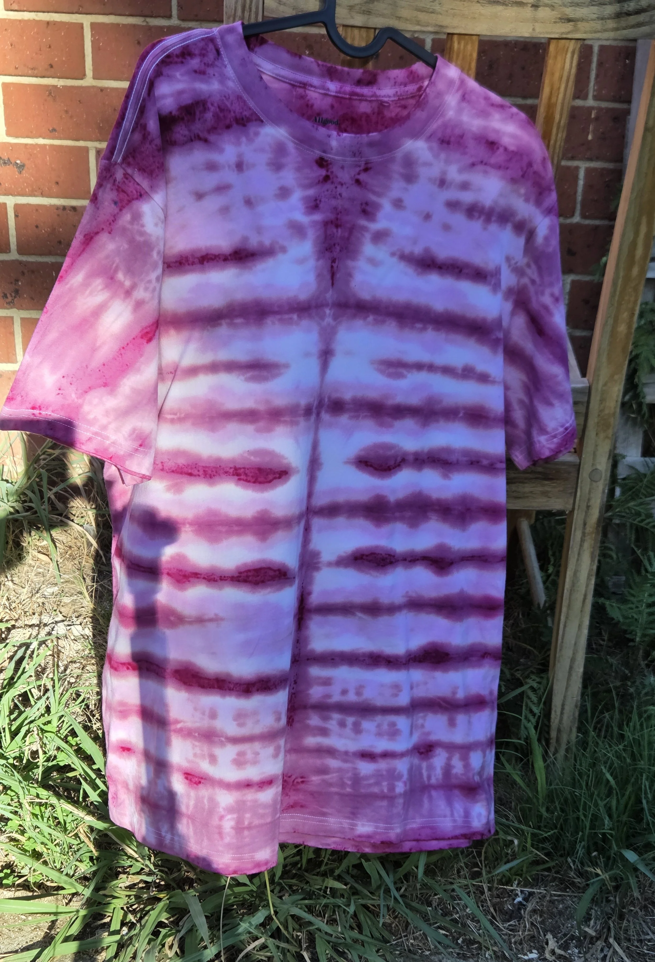 Adult XL hand-dyed 100% cotton T-shirt featuring horizontal candy stripes in shades of dark pink and dusky rose. OOAK textile art by Livity Studio Canberra.