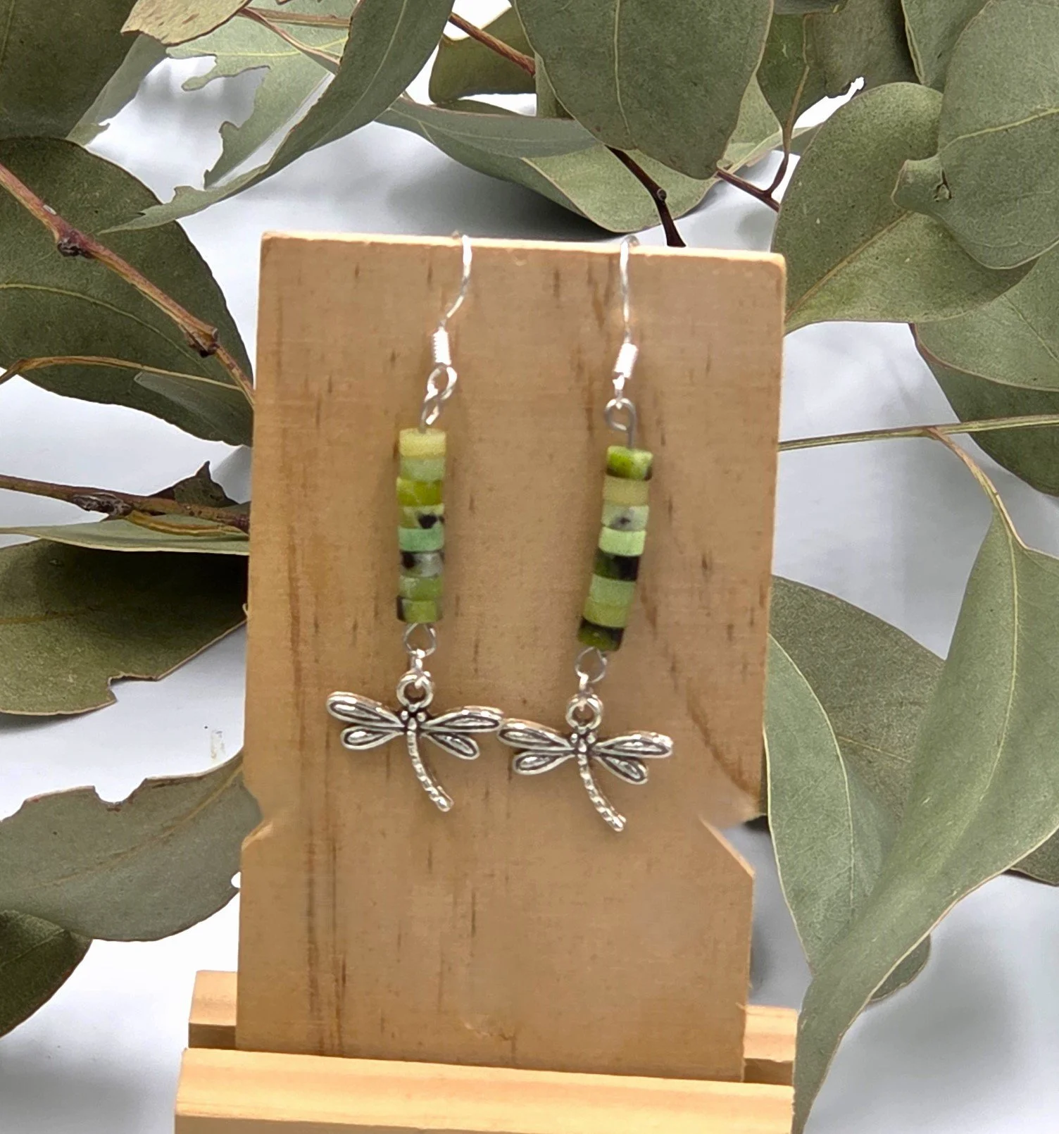 Soft green Chrysoprase beads with a delicate silver dragonfly charm on sterling silver dangle earring hooks.