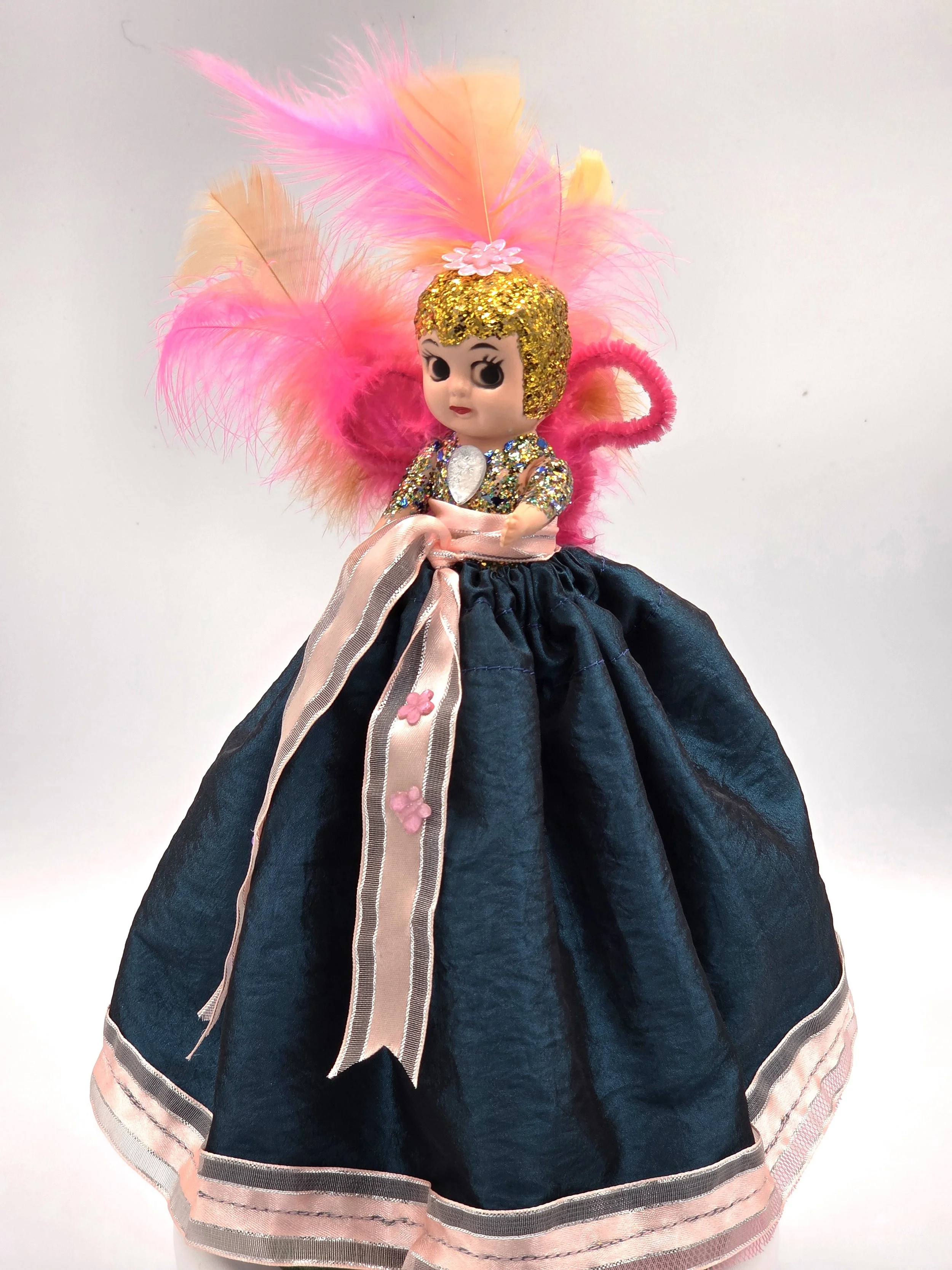 25cm Garden Sprite doll in evergreen taffeta with pink ribbon and feathers.