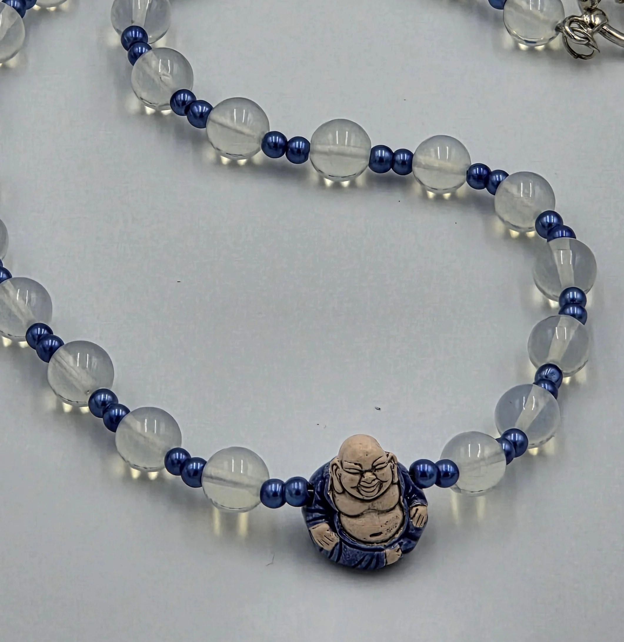 close up of Moonstone and glass necklace with ceramic blue buddah