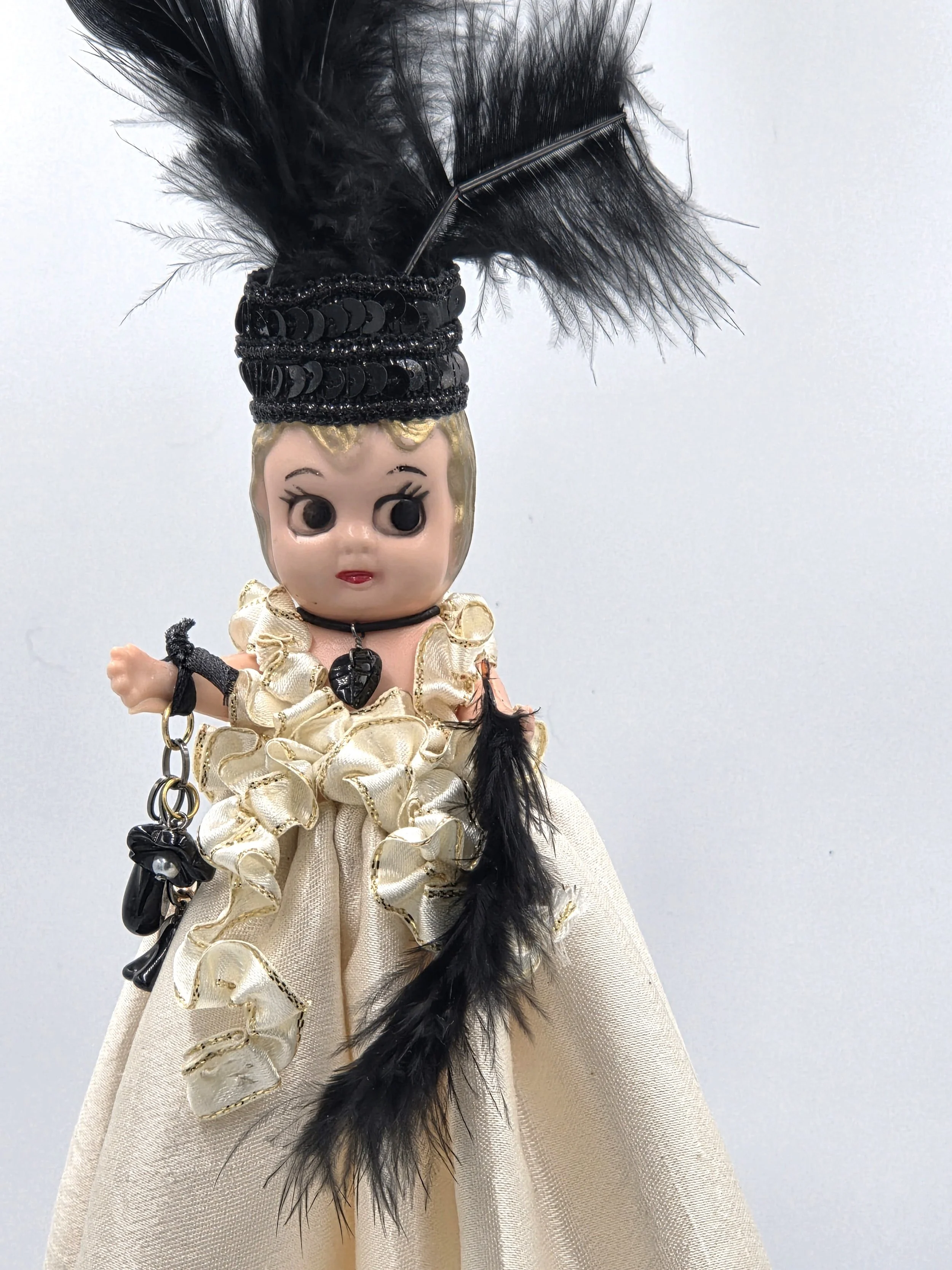 close up Sabina Art Doll Black and ivory themed doll with feathers, sequins and dangling beads