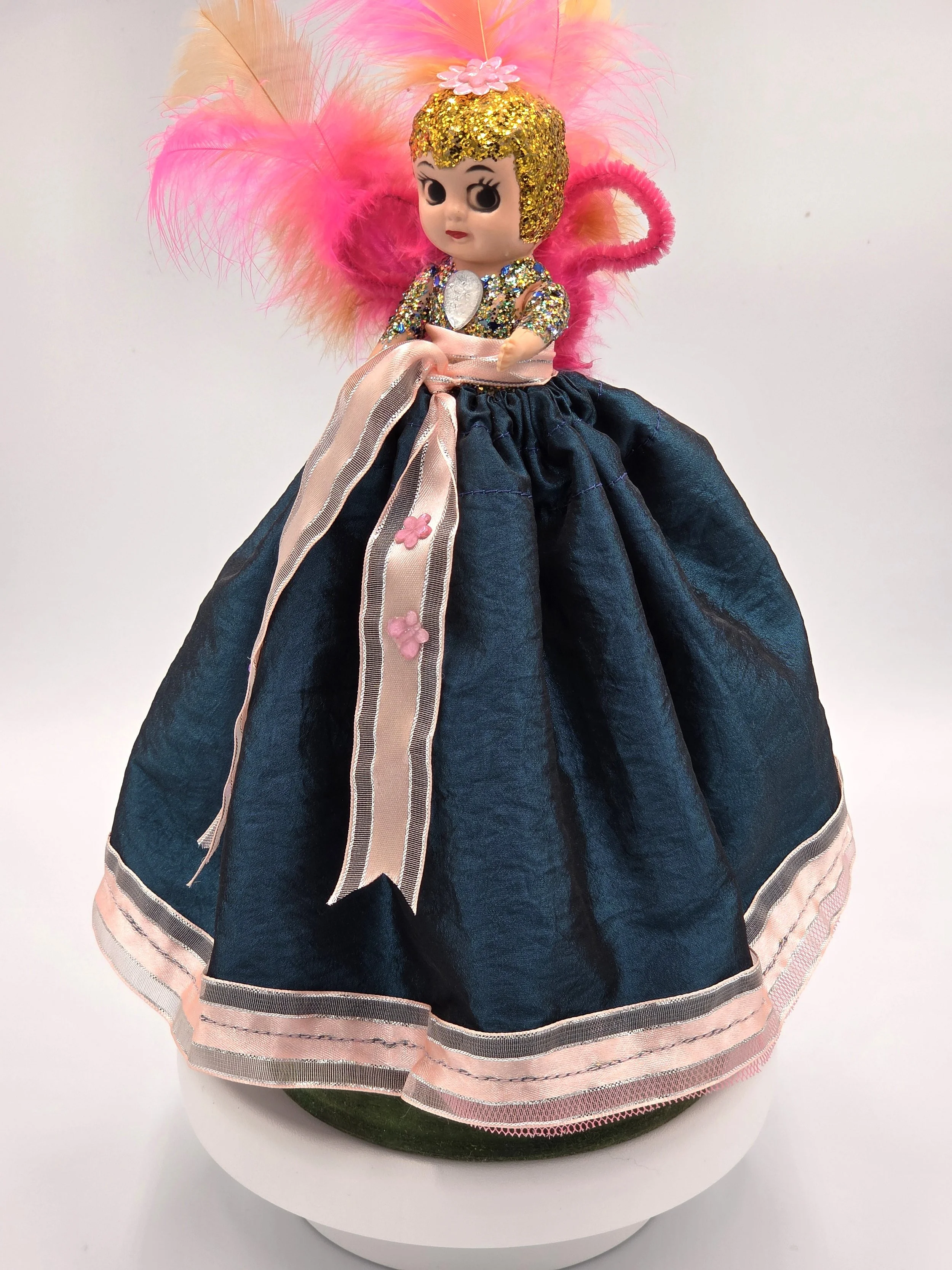Garden Sprite doll in evergreen taffeta with pink ribbon and feathers.