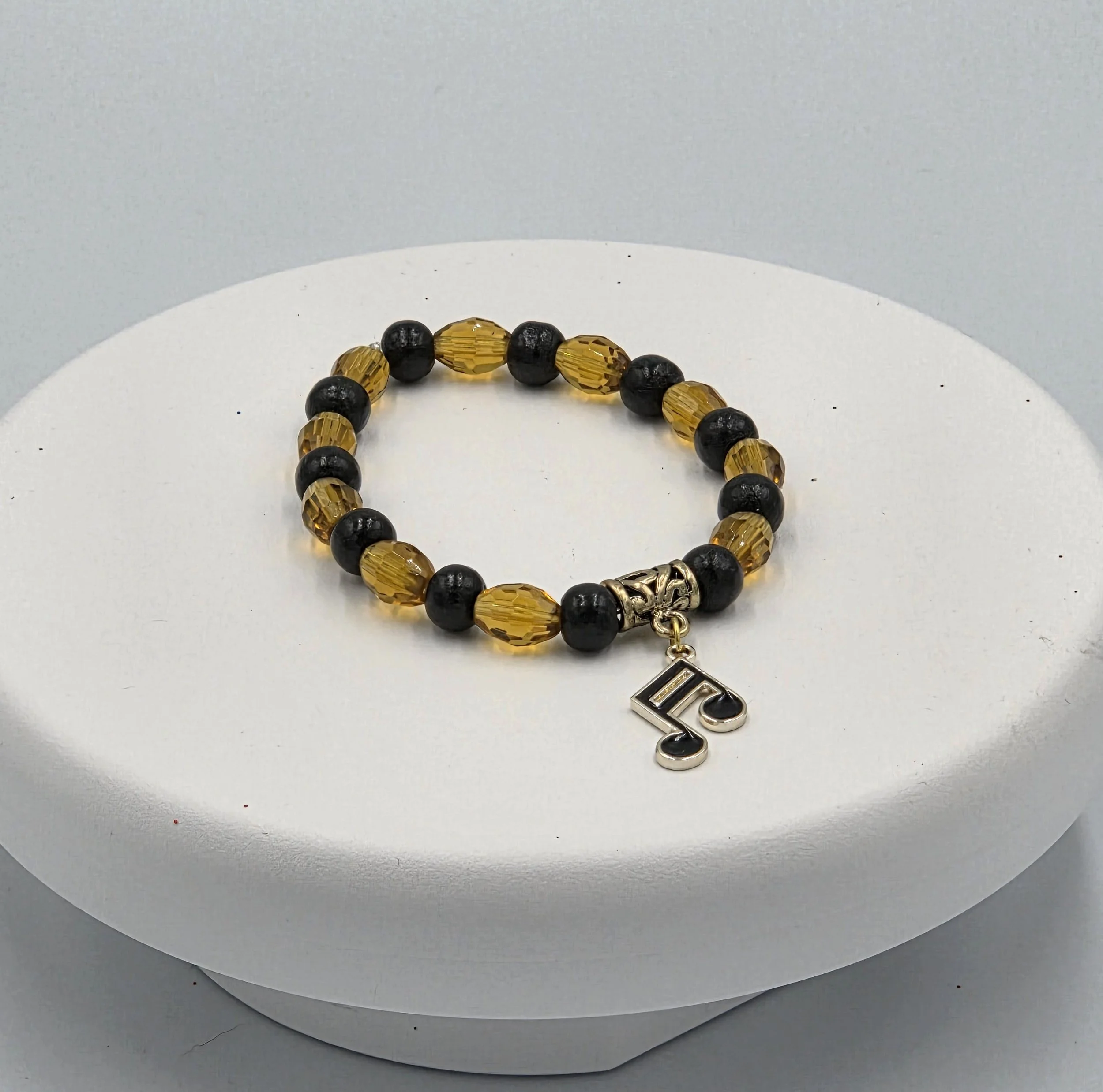 OOAK amber glass and black wood bracelet with gold & black musical note charm.