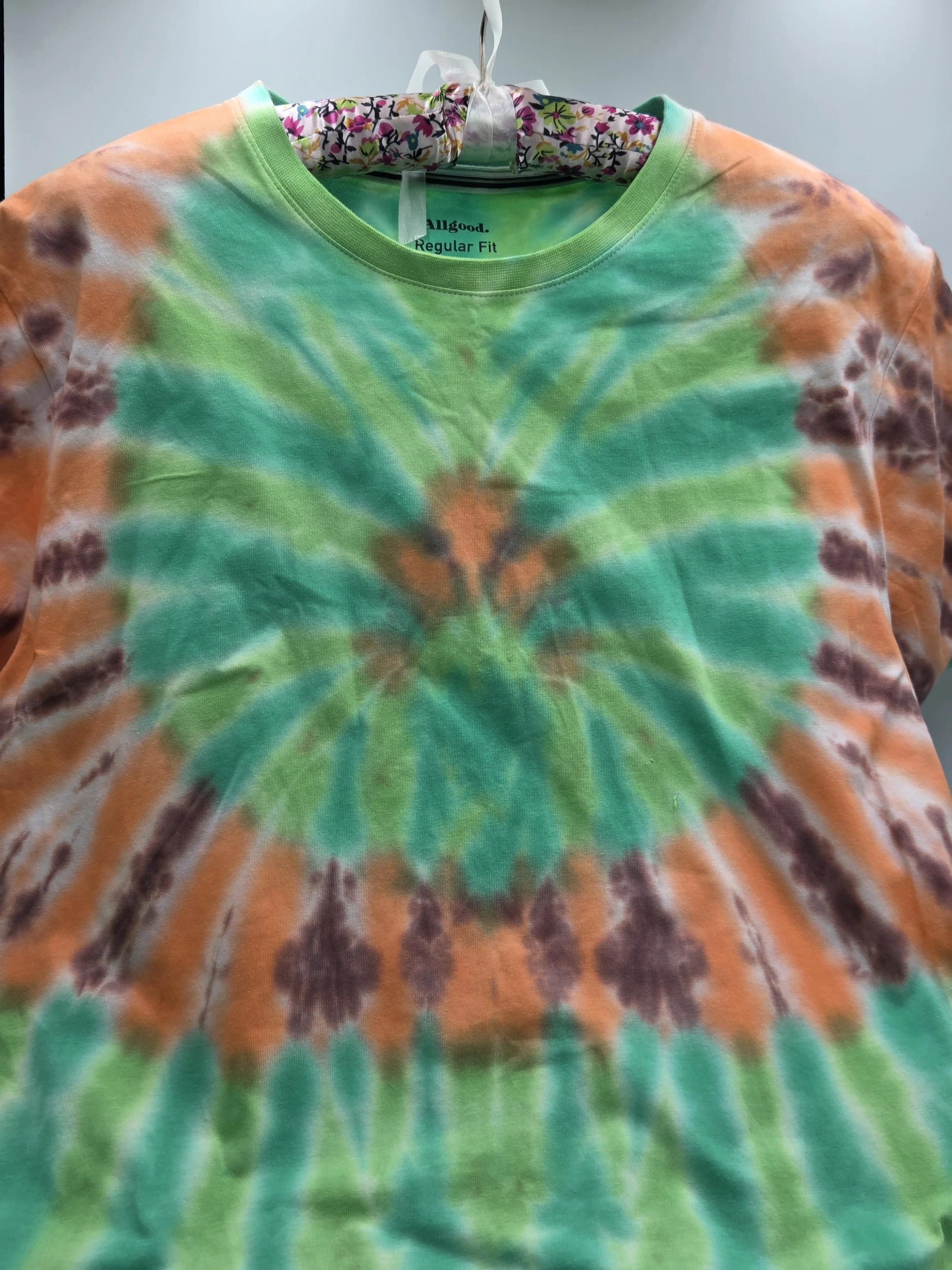 Adult Large hand-dyed green spider T-shirt with an orange and brown circular web frame. OOAK wearable art by Livity Studio Canberra."