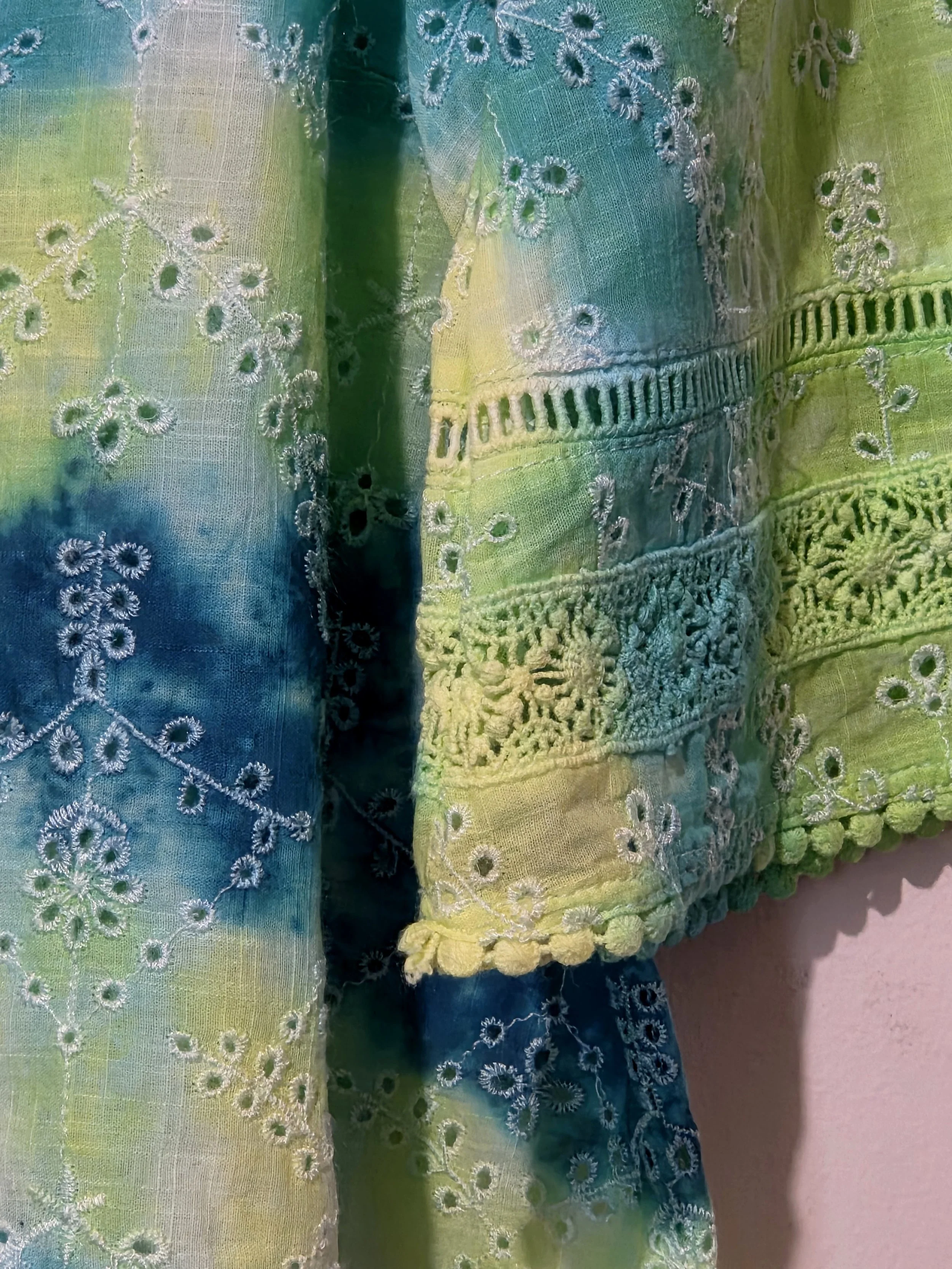 women's size 10 V-neck top with overlocked fern eyelets and horizontal tie-dye bands in green, lime, teal, and yellow.